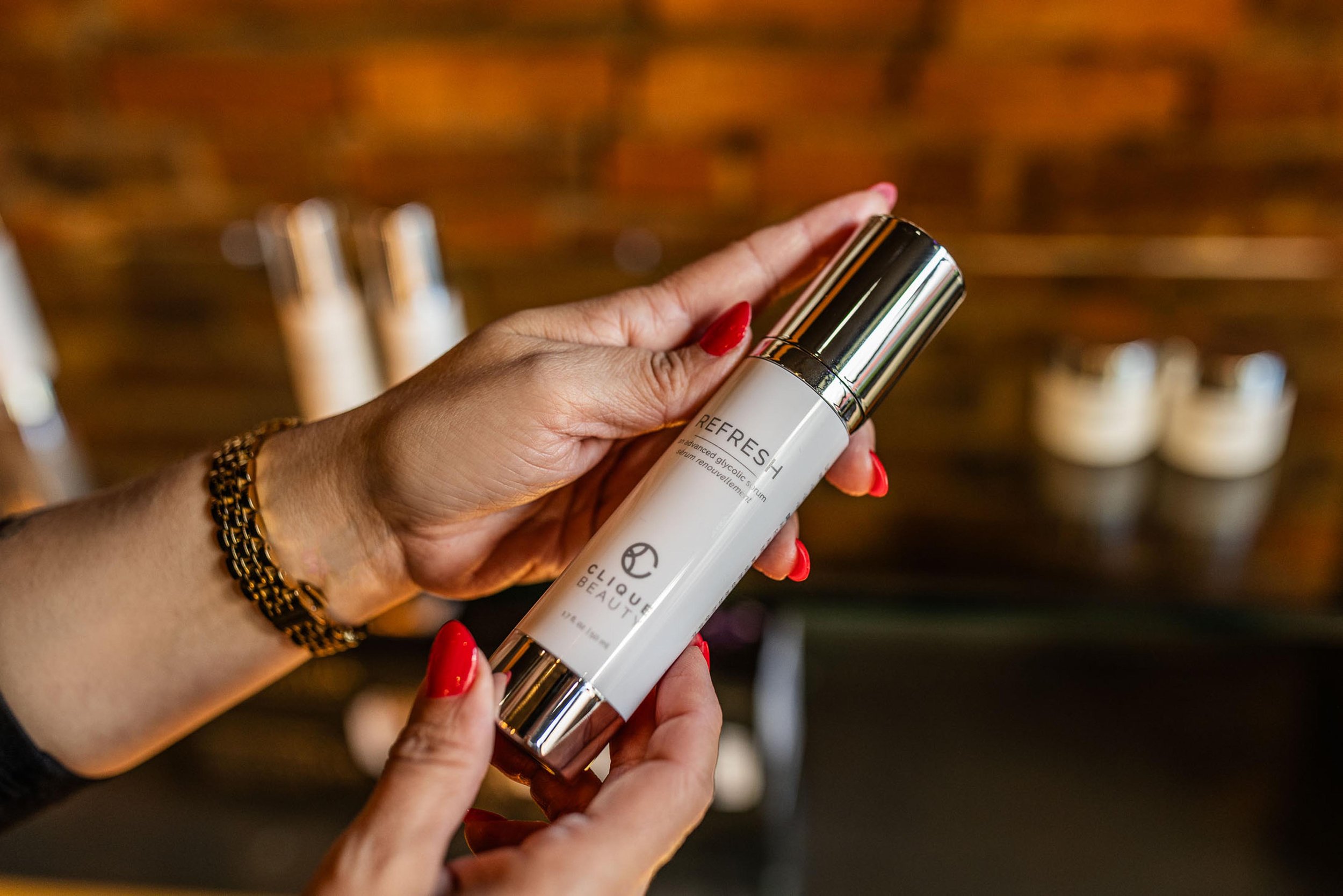 closeup of stylist holding a Clique Beauty skincare product