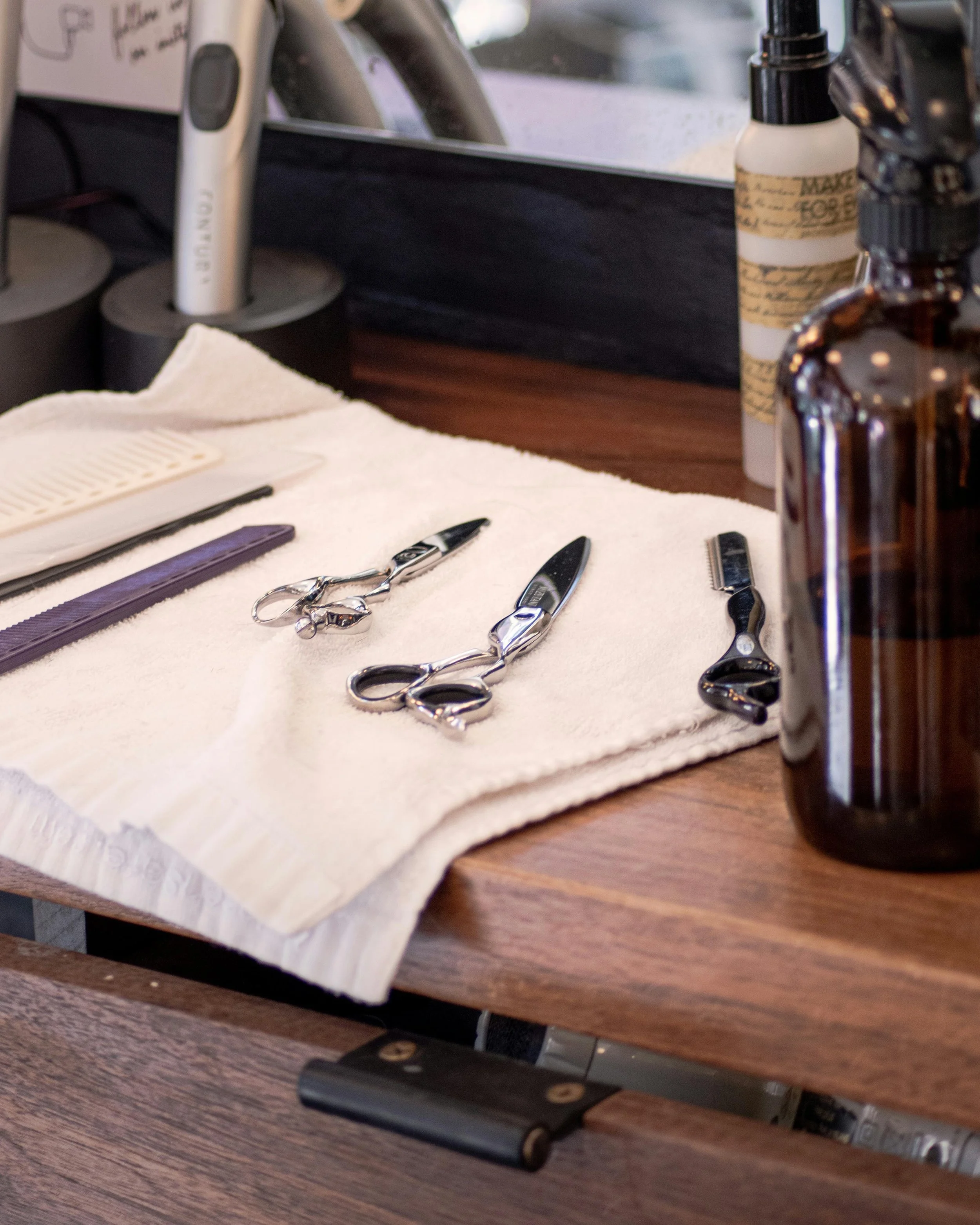 closeup of hair scissors and tools on a work station