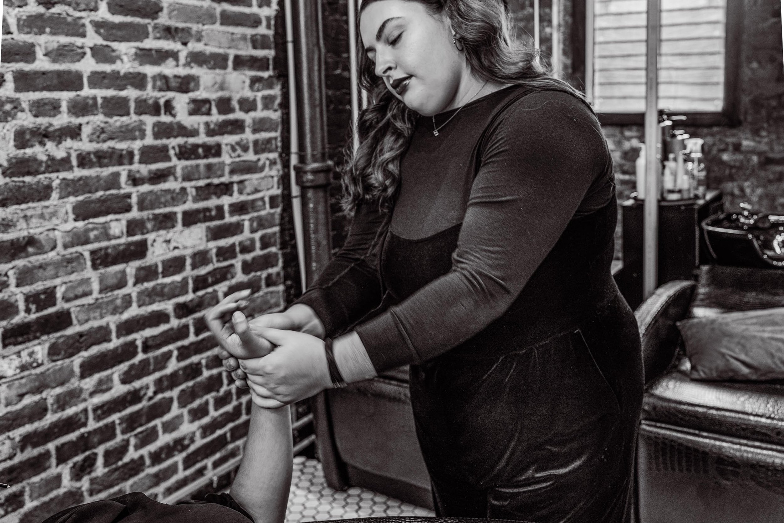 stylist giving a guest a hand massage