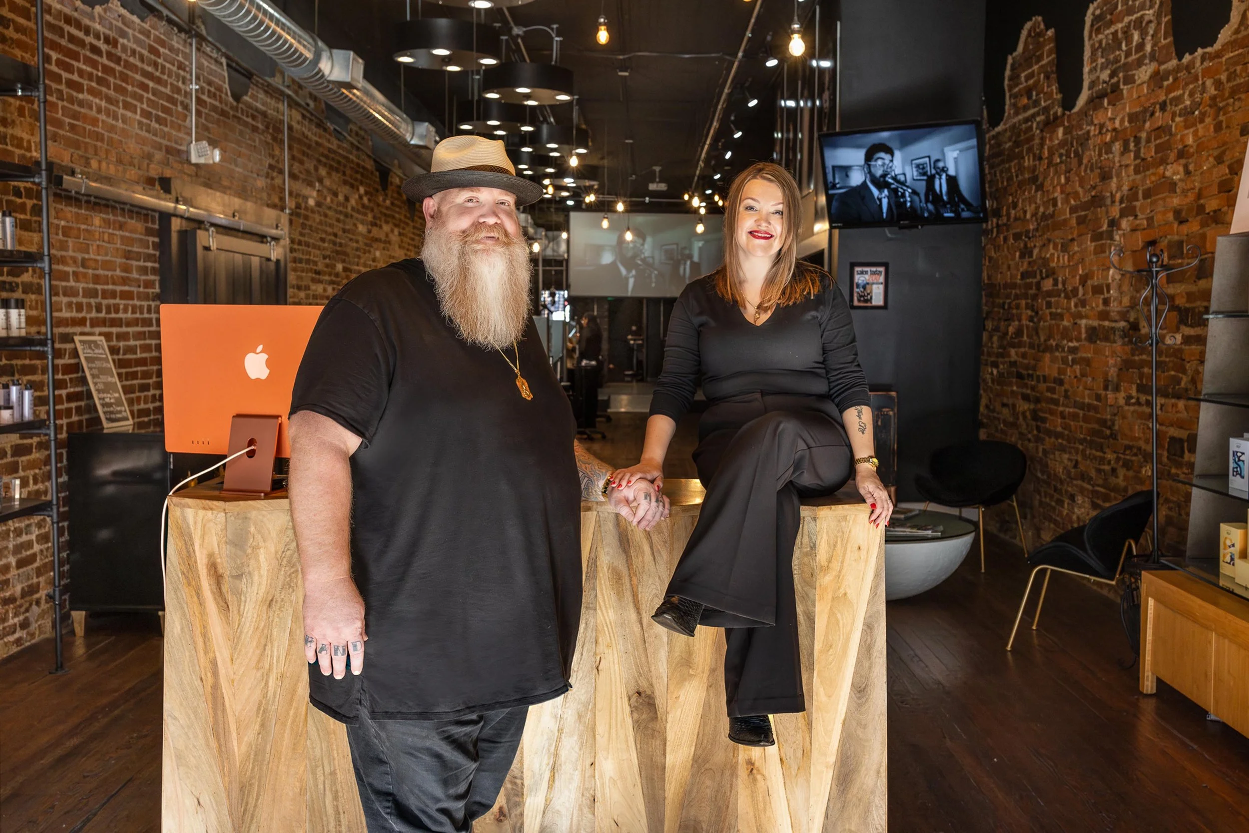 owners Travis and Shanna smiling at the check-in desk