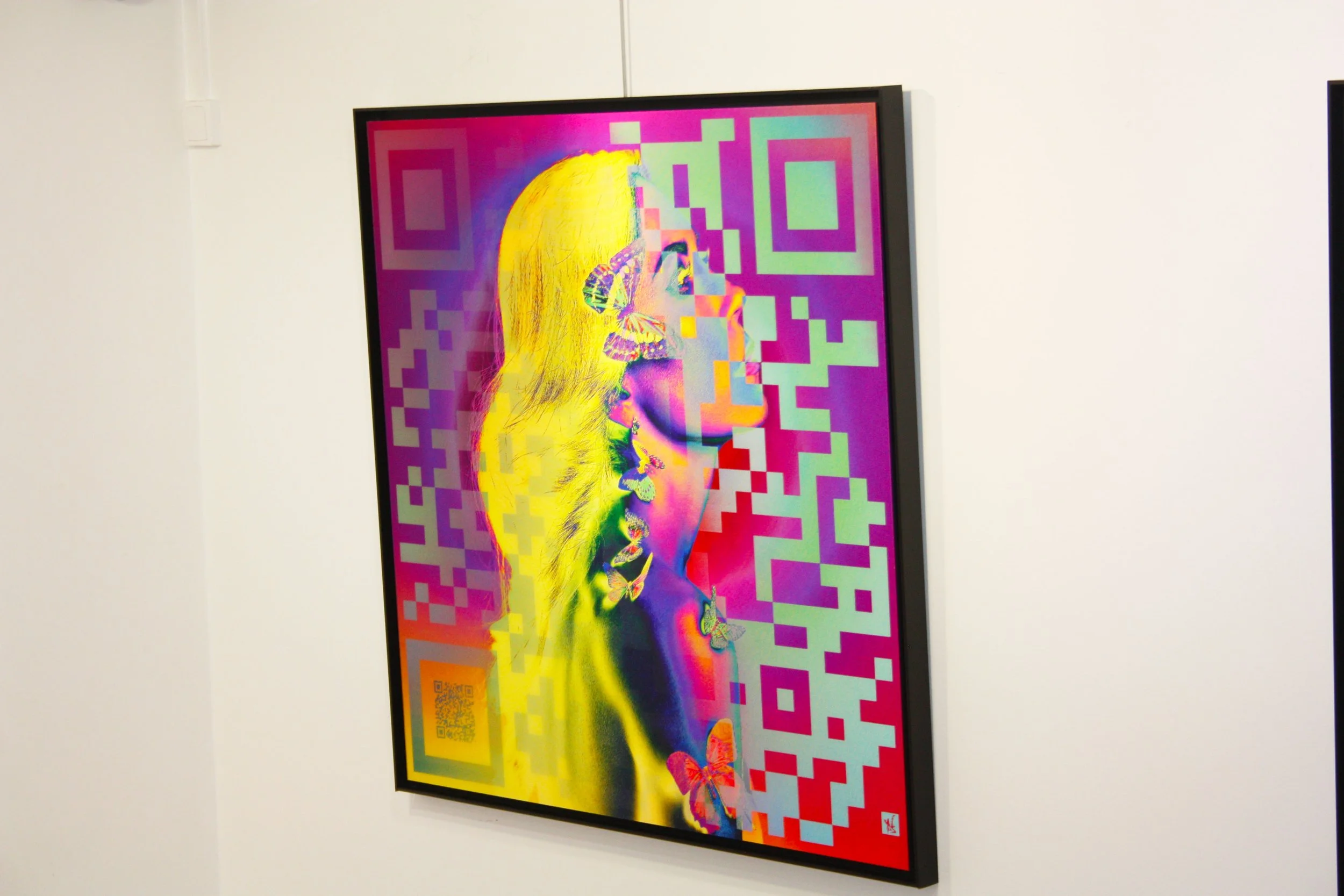 Une peinture numérique colorée représentant un profil de visage féminin avec des papillons et un code QR en bas à gauche, entourée de motifs géométriques en violet, vert, jaune, orange, et rouge.