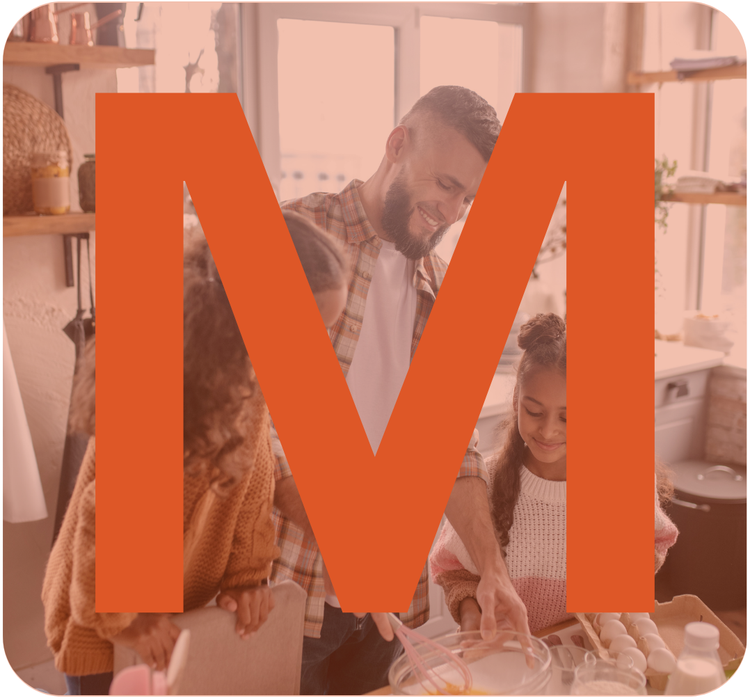 A man and two young girls baking together in a kitchen, smiling and mixing ingredients.