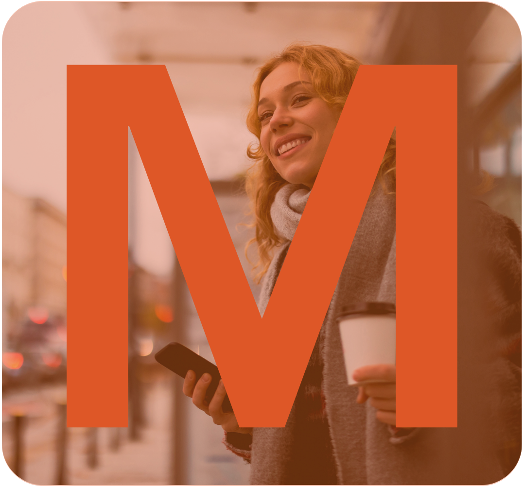 A woman with curly red hair smiling and holding a coffee cup and a smartphone in an indoor space, with a large orange Netflix logo overlapping the image.