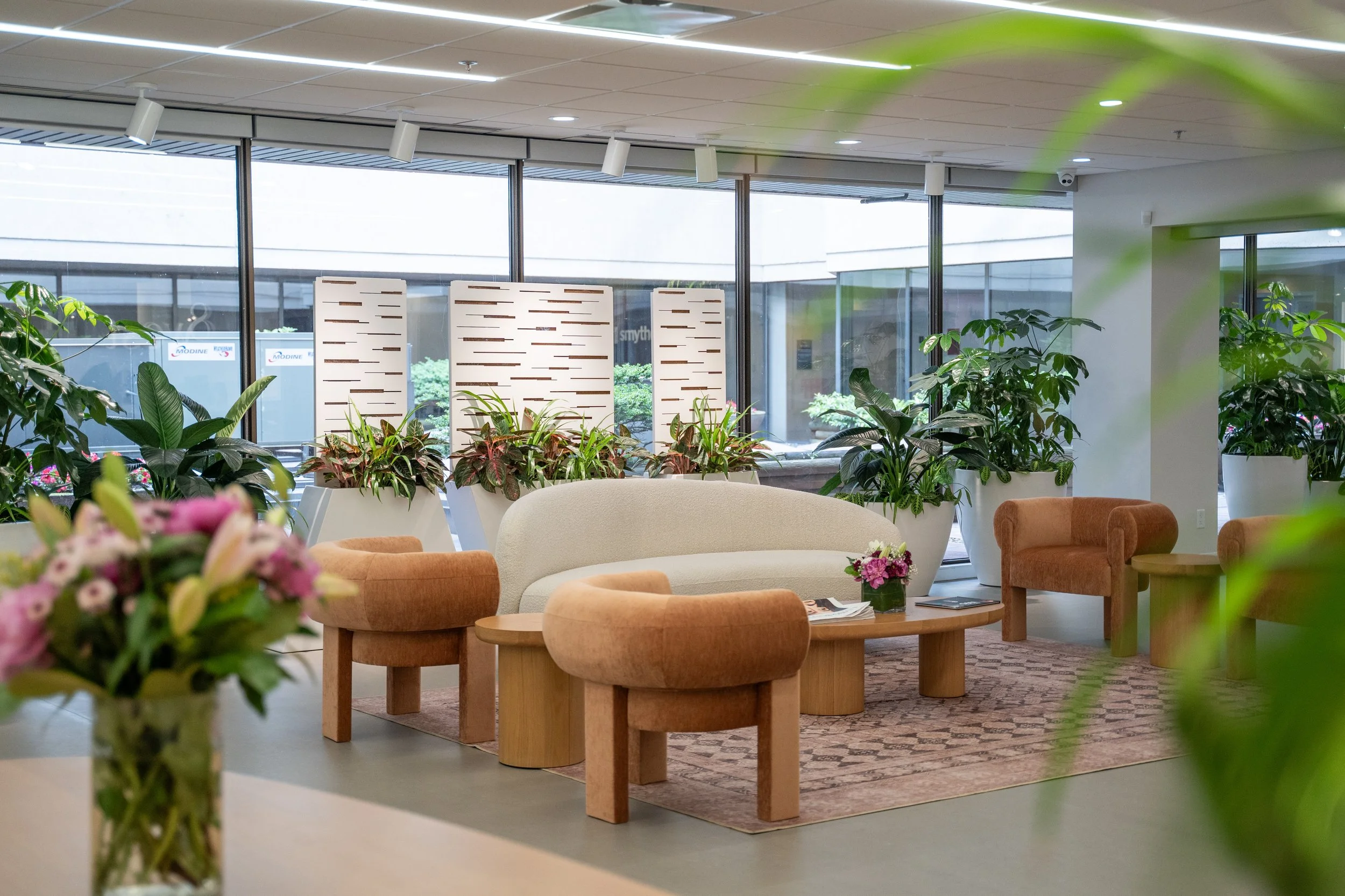 View of the stylish front desk at 8West North Vancouver, featuring custom-built product shelving stocked with premium wellness supplements, skincare, and health products. This thoughtful retail integration allows clients to browse high-quality items 