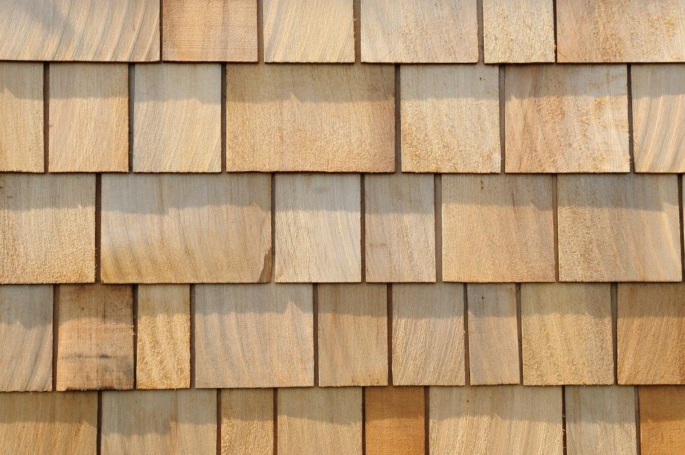 Close-up of wooden shingle siding on a building.