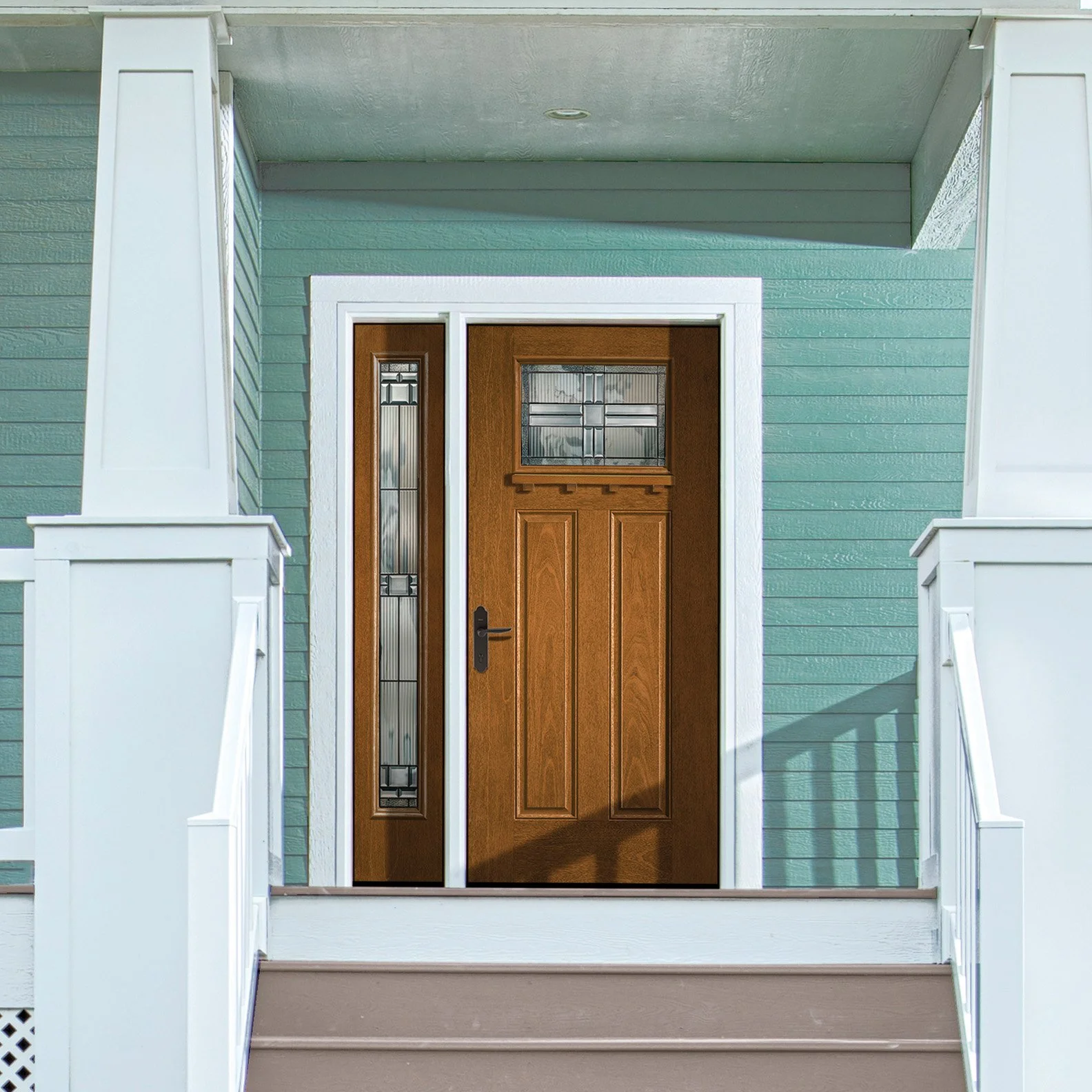 Front porch with a wooden door, a side window, and white railings leading to steps.