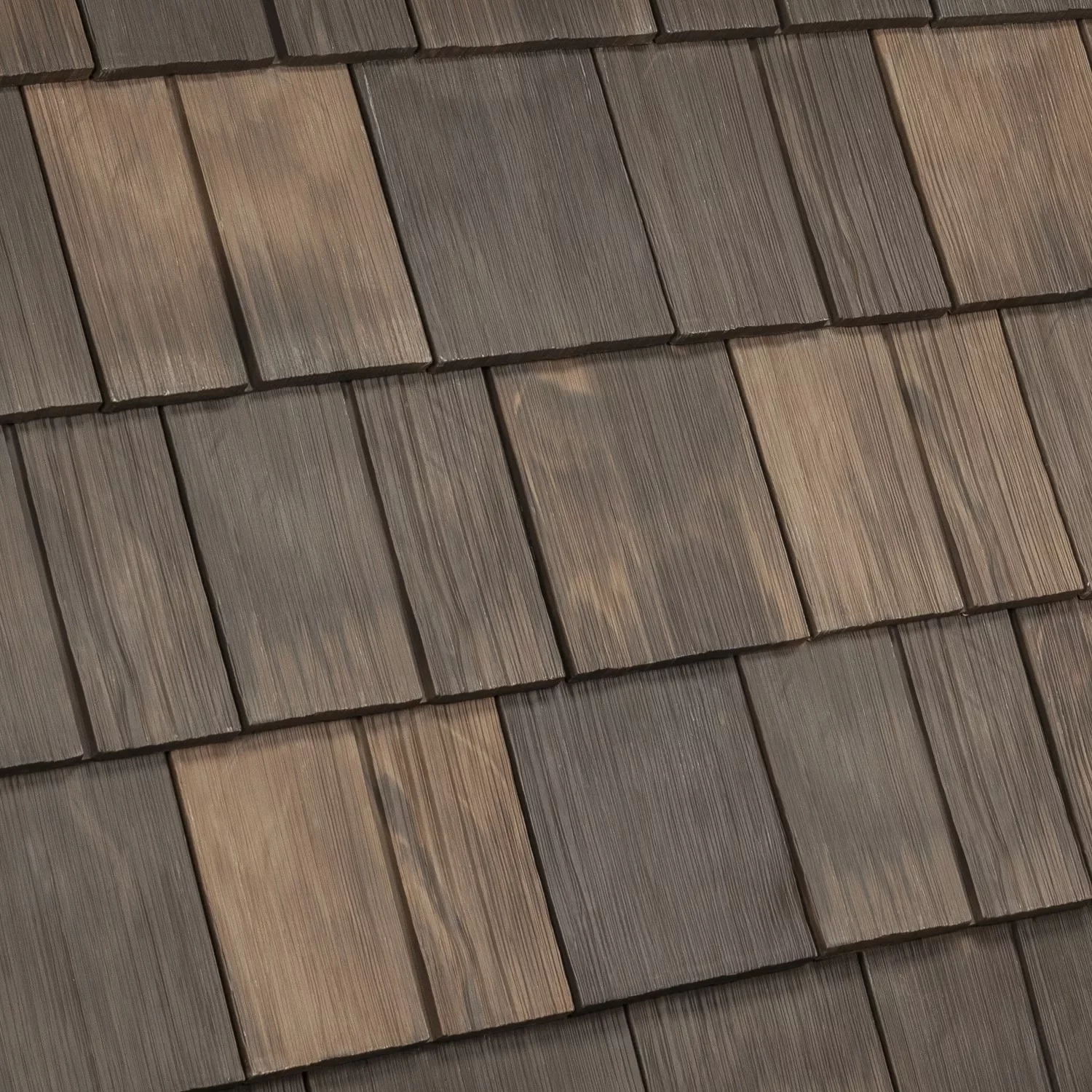 Close-up of brown wooden shingles on a roof, arranged in horizontal rows.
