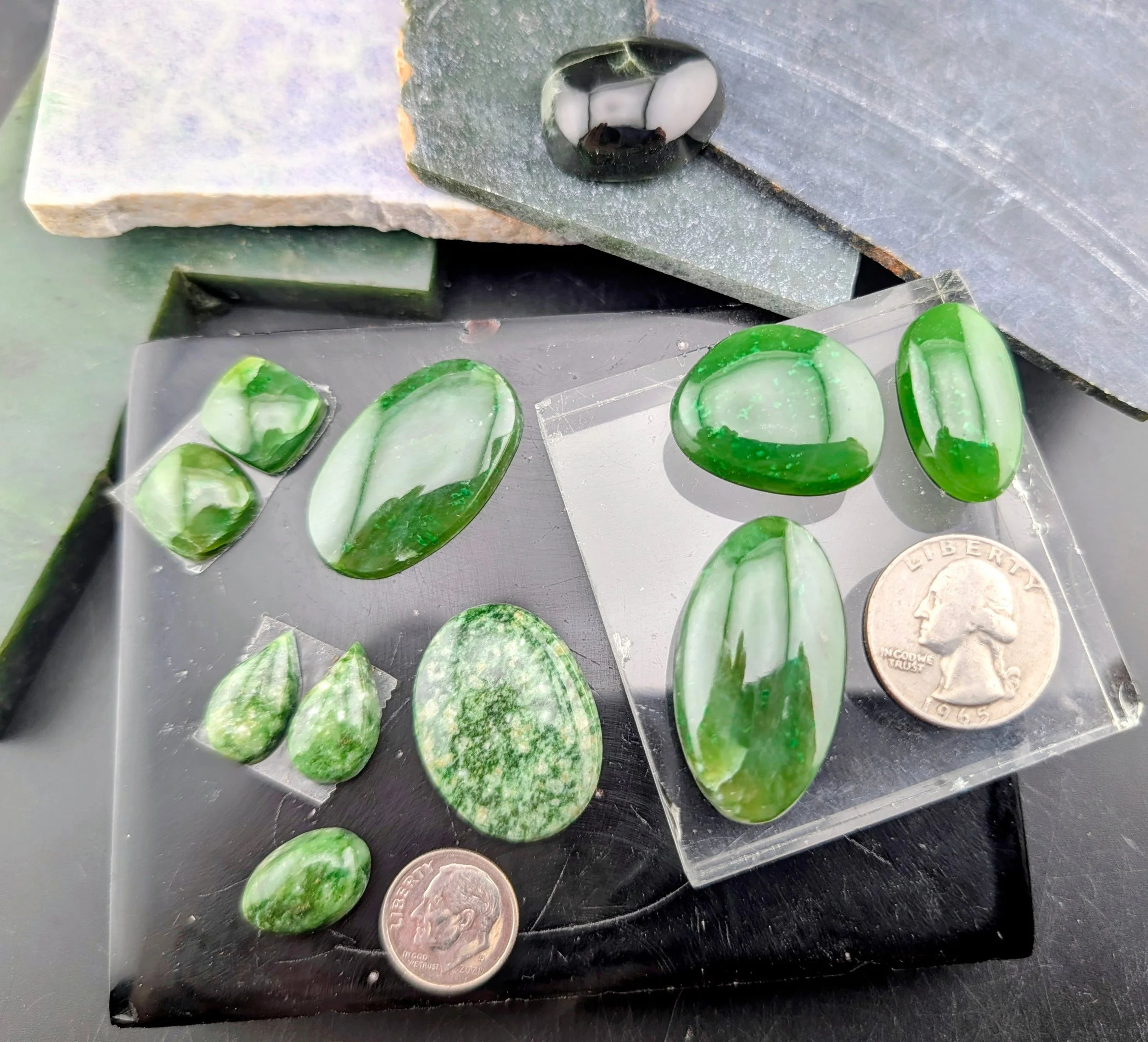 Green Jade (Nephrite) from Canada and Green Snowflake Jade (Nephrite) from Wyoming. Beautiful shade of green and with a very "jelly" quality. These cabs are available at a discount price of $1.50/carat. Across the top of the picture, you se