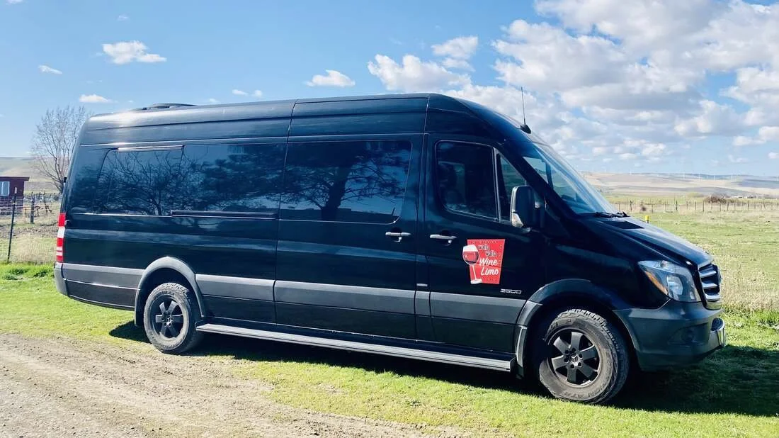 Black Sprinter van parked near vineyards in the Walla Walla Valley.
