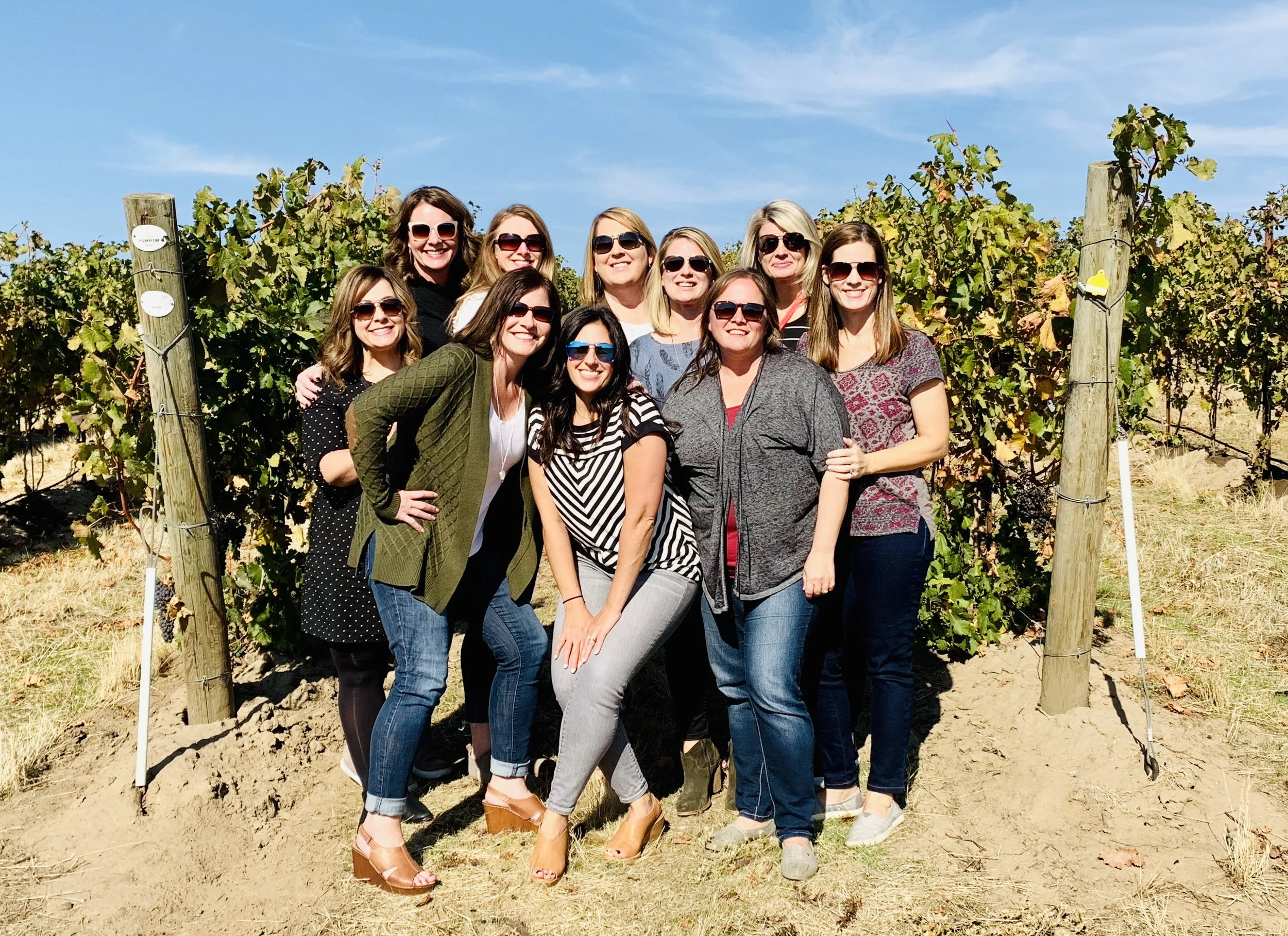 Group of  wine tasters standing together in a vineyard in the Walla Walla Valley. 