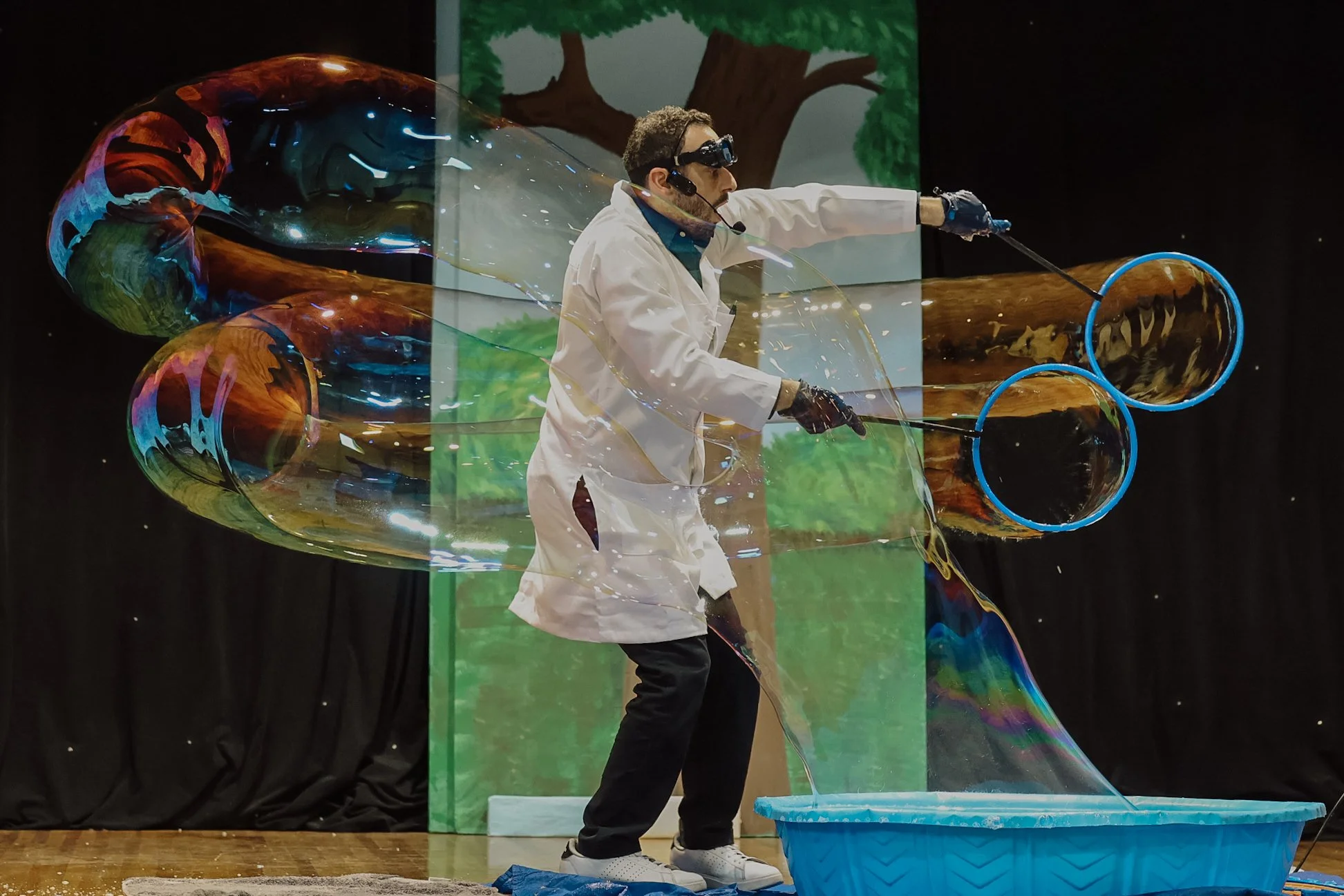 Kids playing at an interactive bubble playtime station at a Colorado birthday party