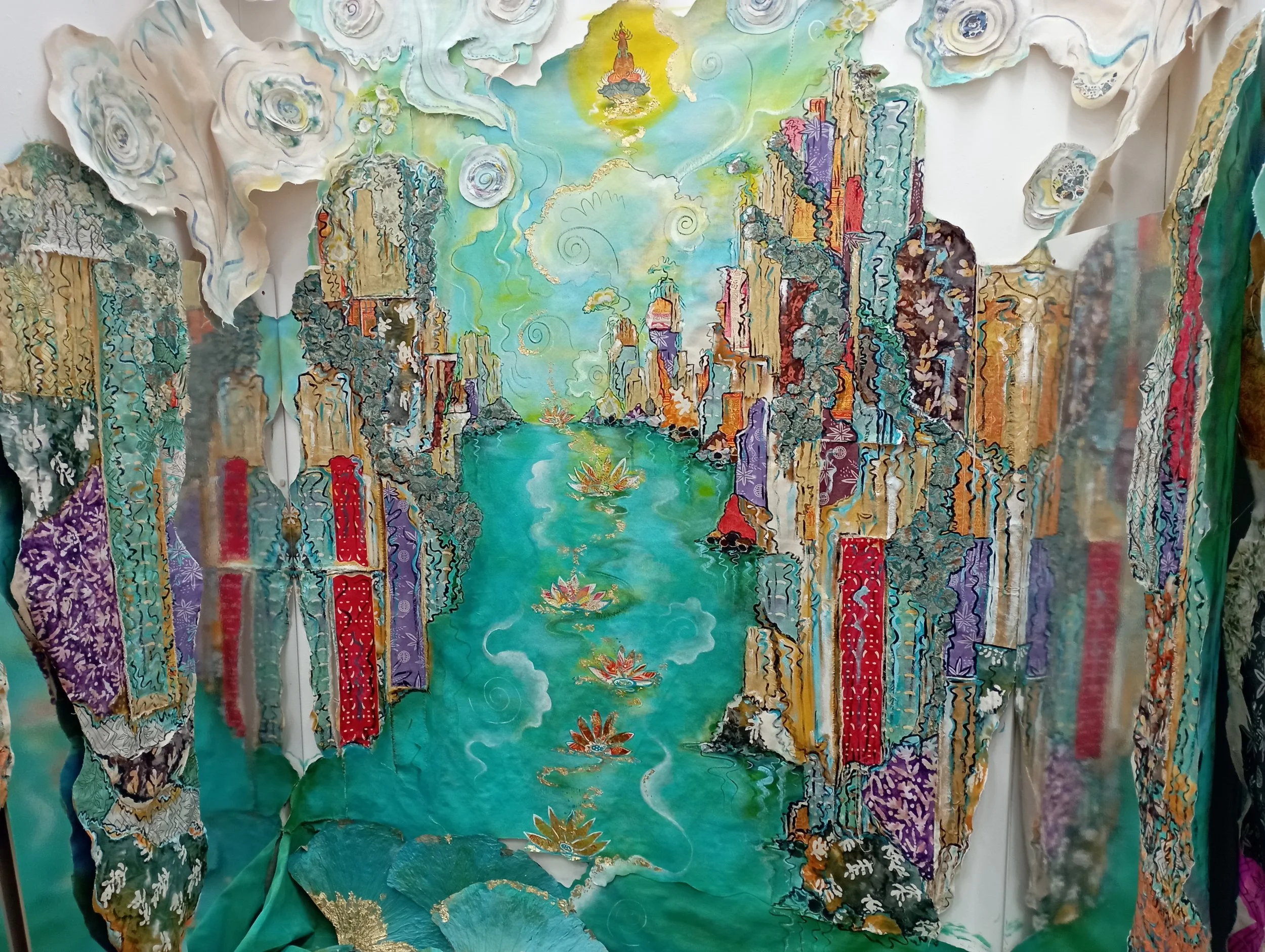 A colorful, textured painting of a river with waterfalls, surrounded by tall, abstract mountains and a yellow-green sky with clouds and swirling patterns.