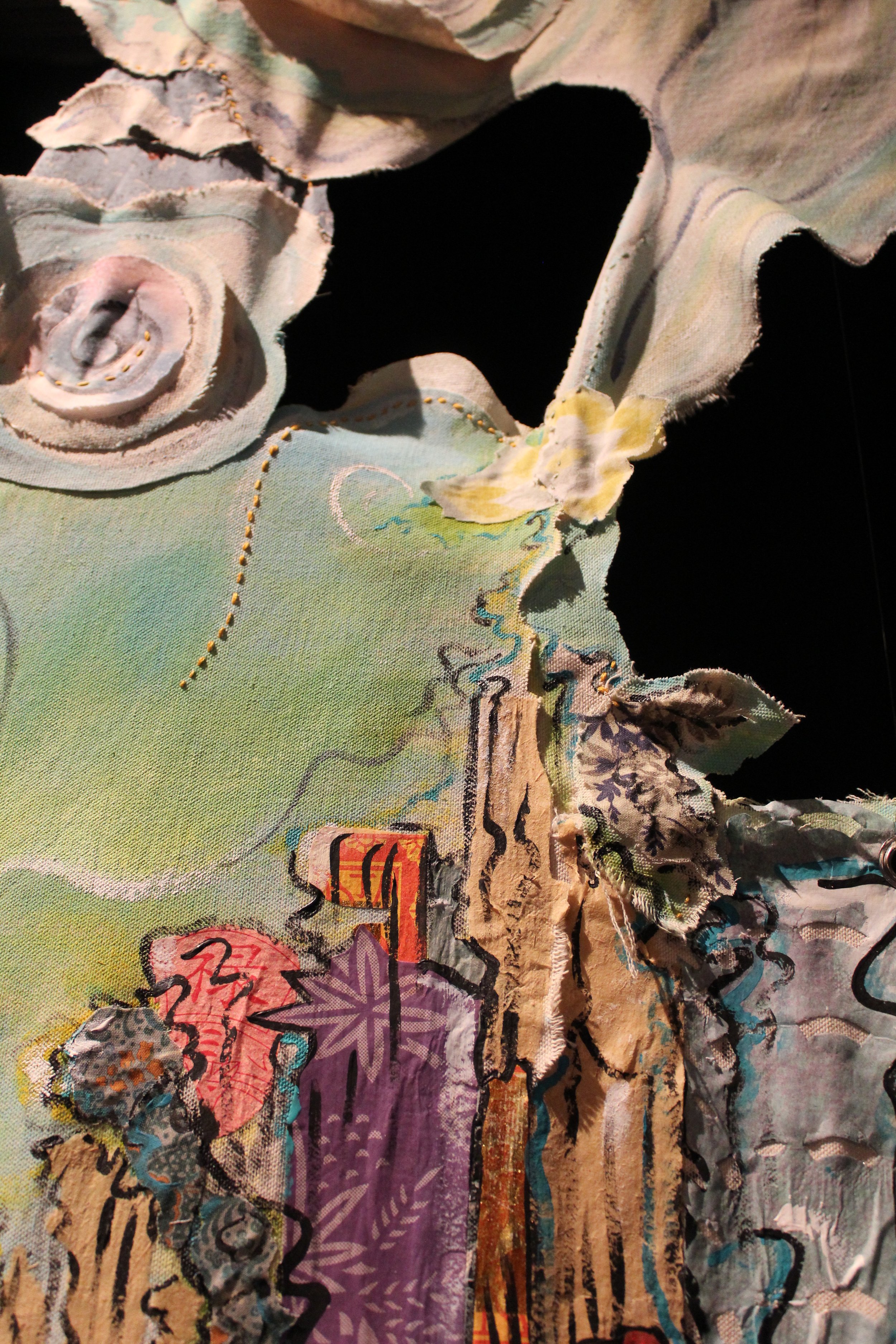 Close up detail combining canvas, acrylic, fabric and joss paper.