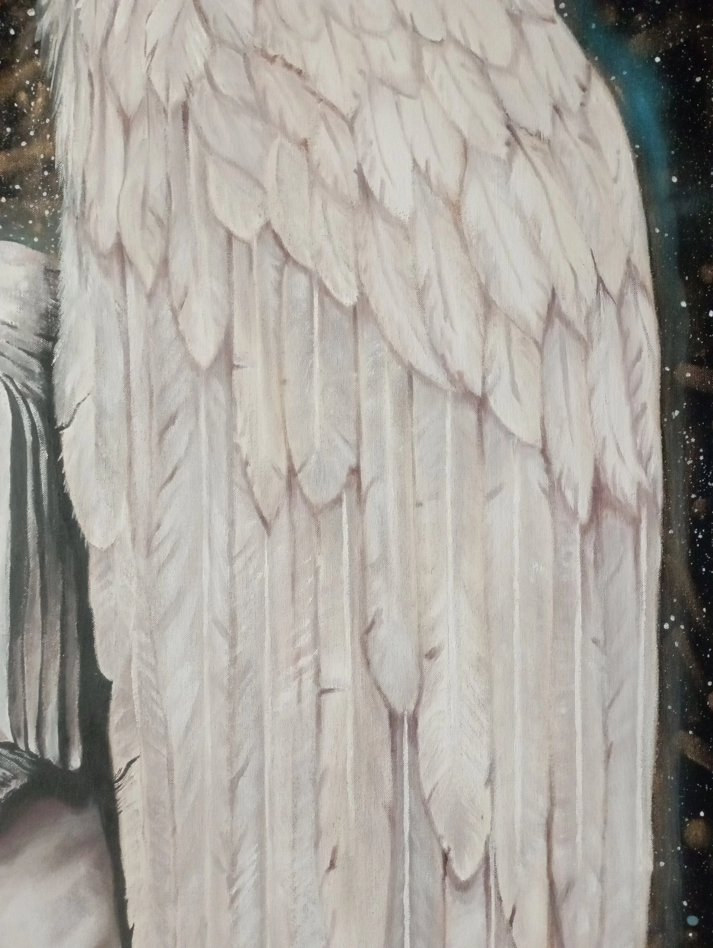 Close-up of a wooden surface with carved feathers and a cosmic background with stars.