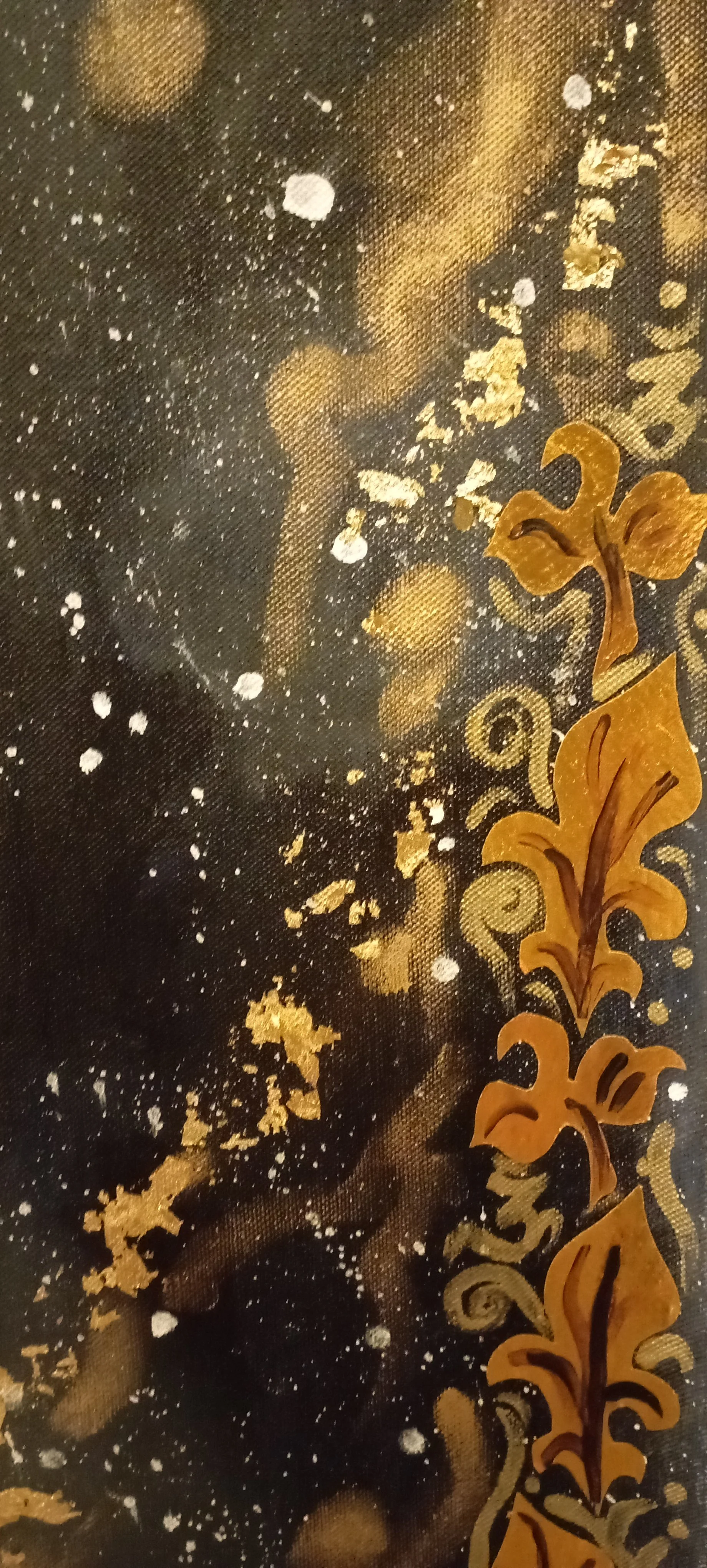 Close-up of artist's canvas with abstract black and gold design featuring swirling patterns and gold leaf accents.