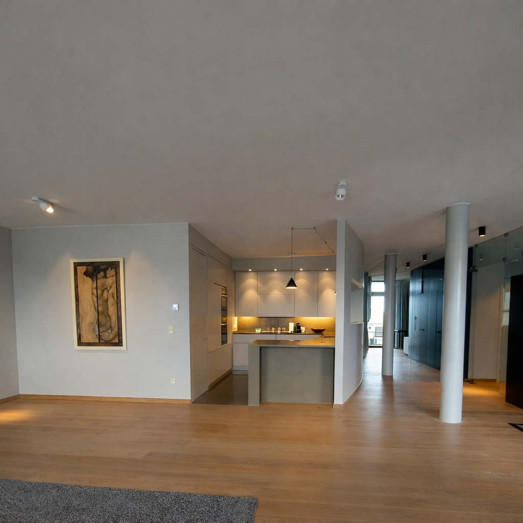 Modern open-concept living space with a kitchen featuring white cabinets, a breakfast bar, pendant lighting, and a hardwood floor.