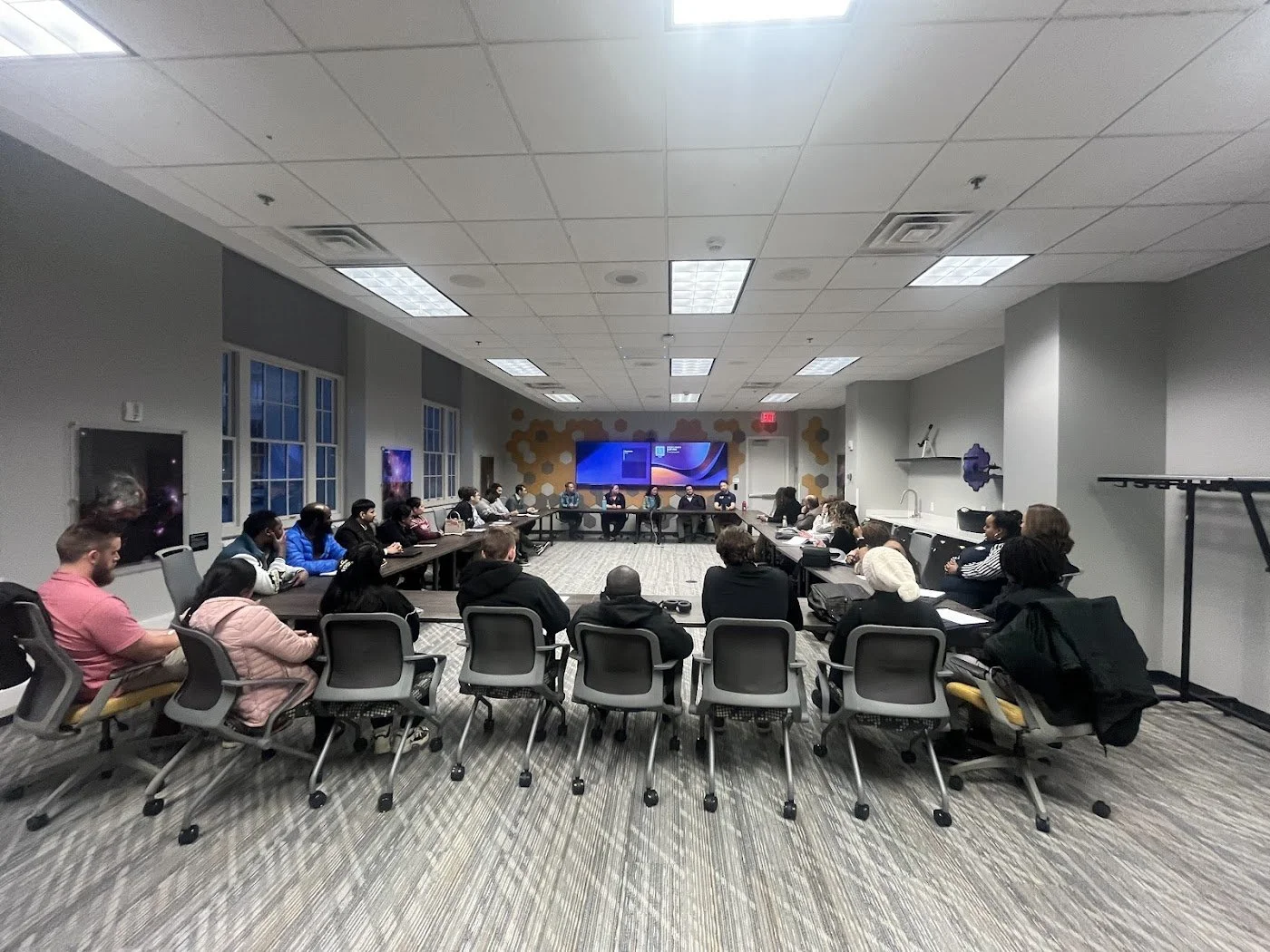 Panel conversation in conference room featuring open square set up and workforce development conversations