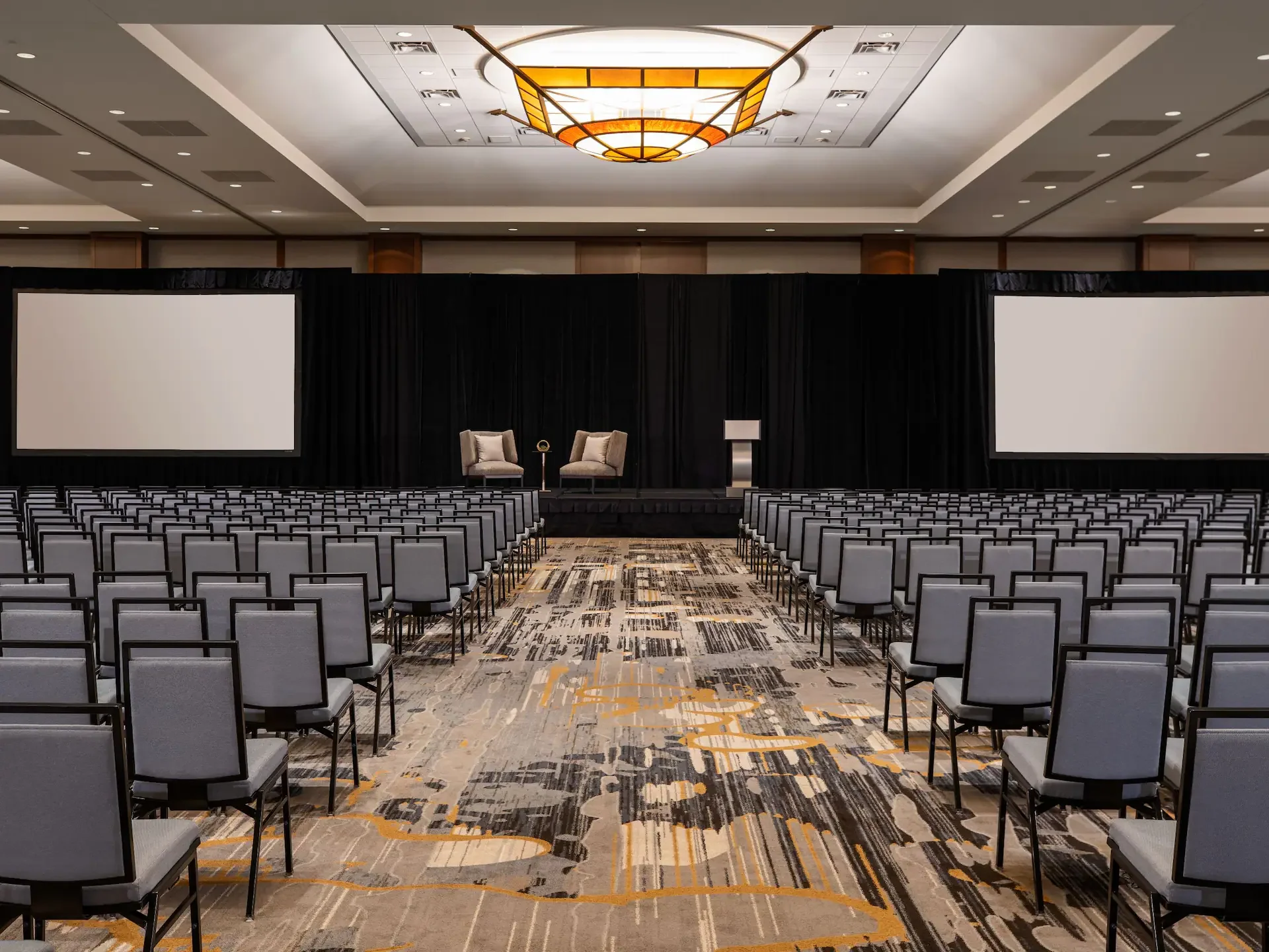 banquet ballroom set up with podium for fireside chat corporate event