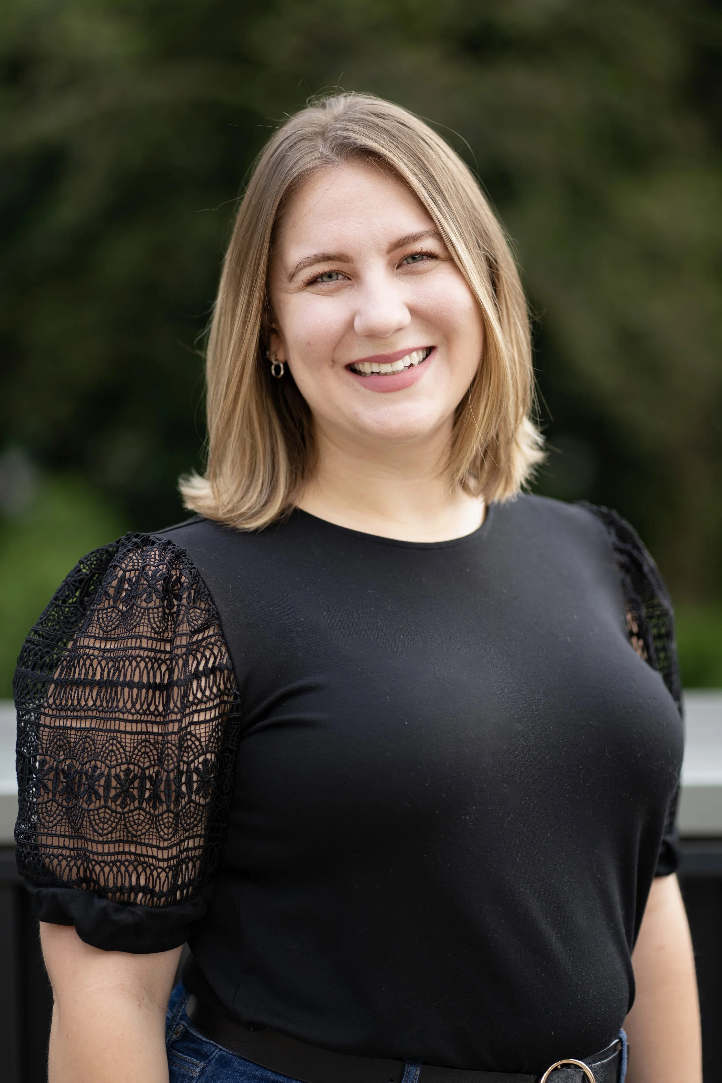 Head shot photo of smiling woman in black blouse.  Makenzie Skinner, Columbus Ohio Event Manager
