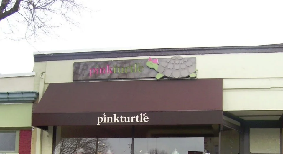 Storefront with a sign that says 'pinkturtle' and a 3D turtle logo with a pink bow on its head