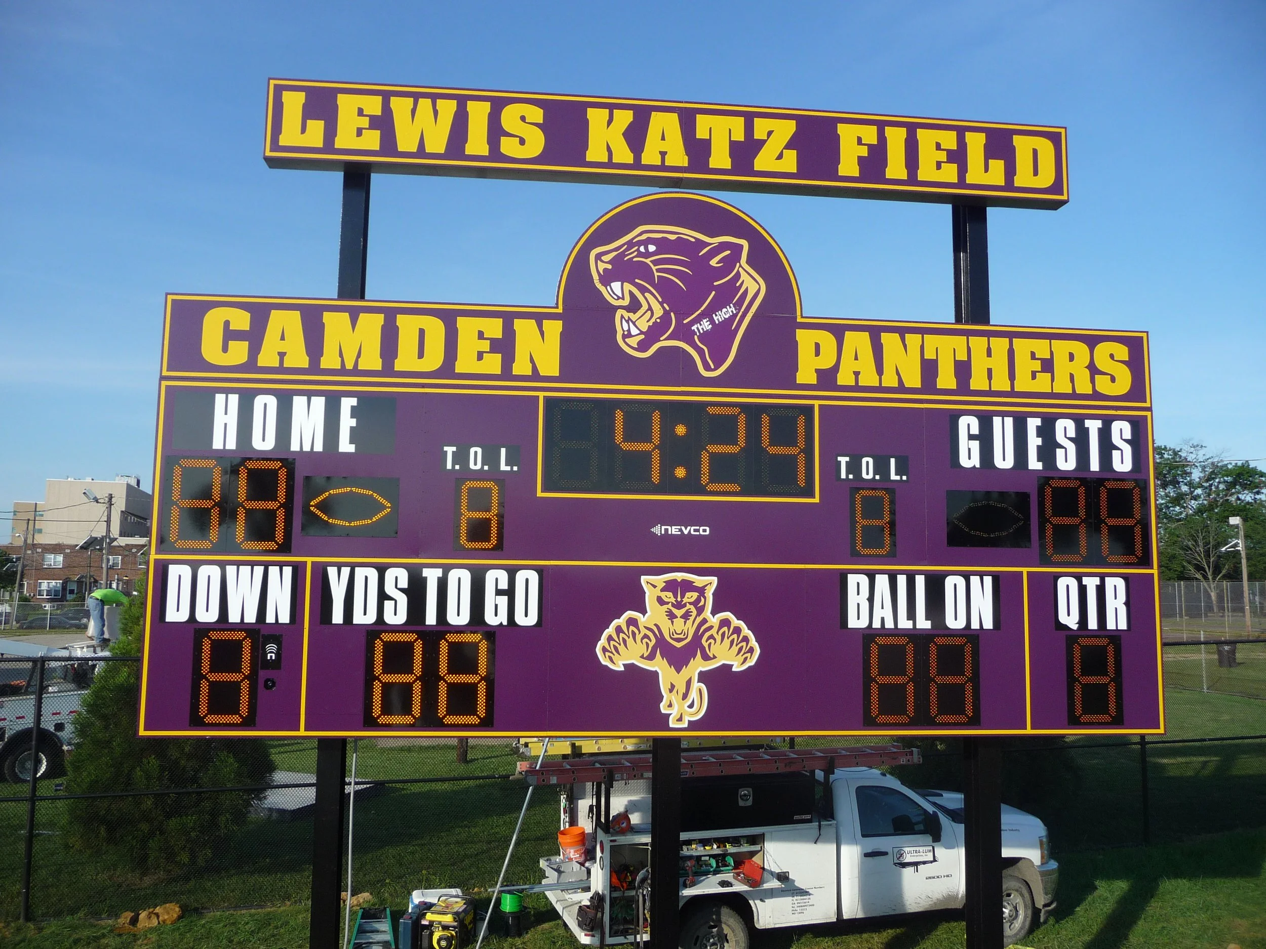 Scoreboard at Lewis Katz Field for Camden Panthers, showing time 4:24 and other game details, with purple and yellow team branding and logo.