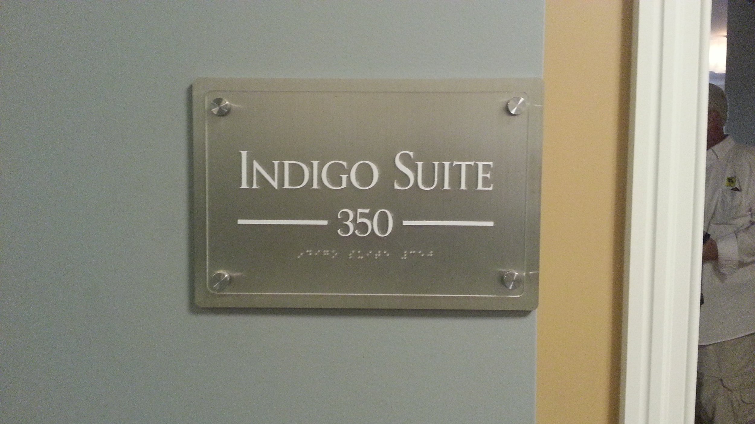 Sign reading 'Indigo Suite 350' on a wall.