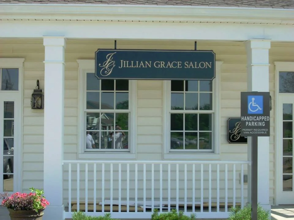 Exterior of Jillian Grace Salon with a handicap parking sign in front.