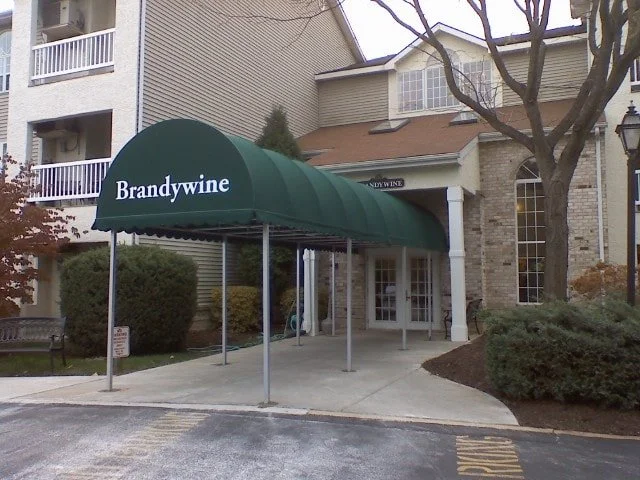 Green awning with the word "Brandywine" in front of a residential building entrance