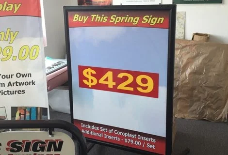 Signboard advertising a spring sign for $429, including a set of coroplast inserts, priced at an additional $79.