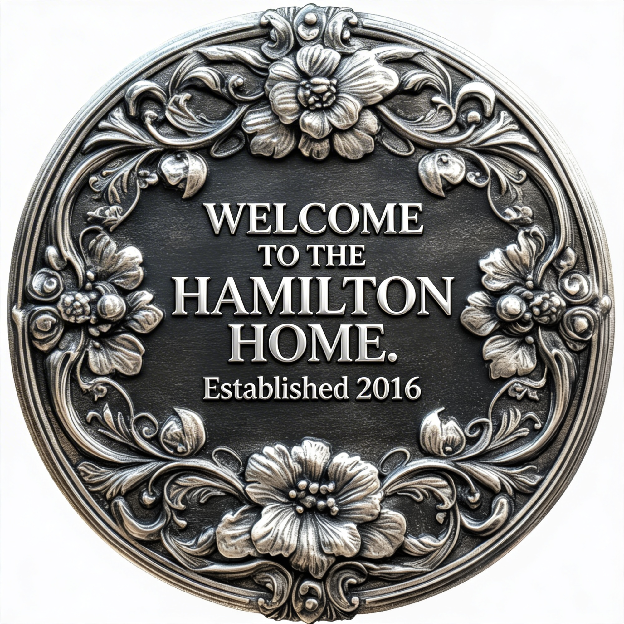 Decorative metal plaque with floral and leaf patterns surrounding a central text that reads "Welcome to the Hamilton Home," established in 2016.