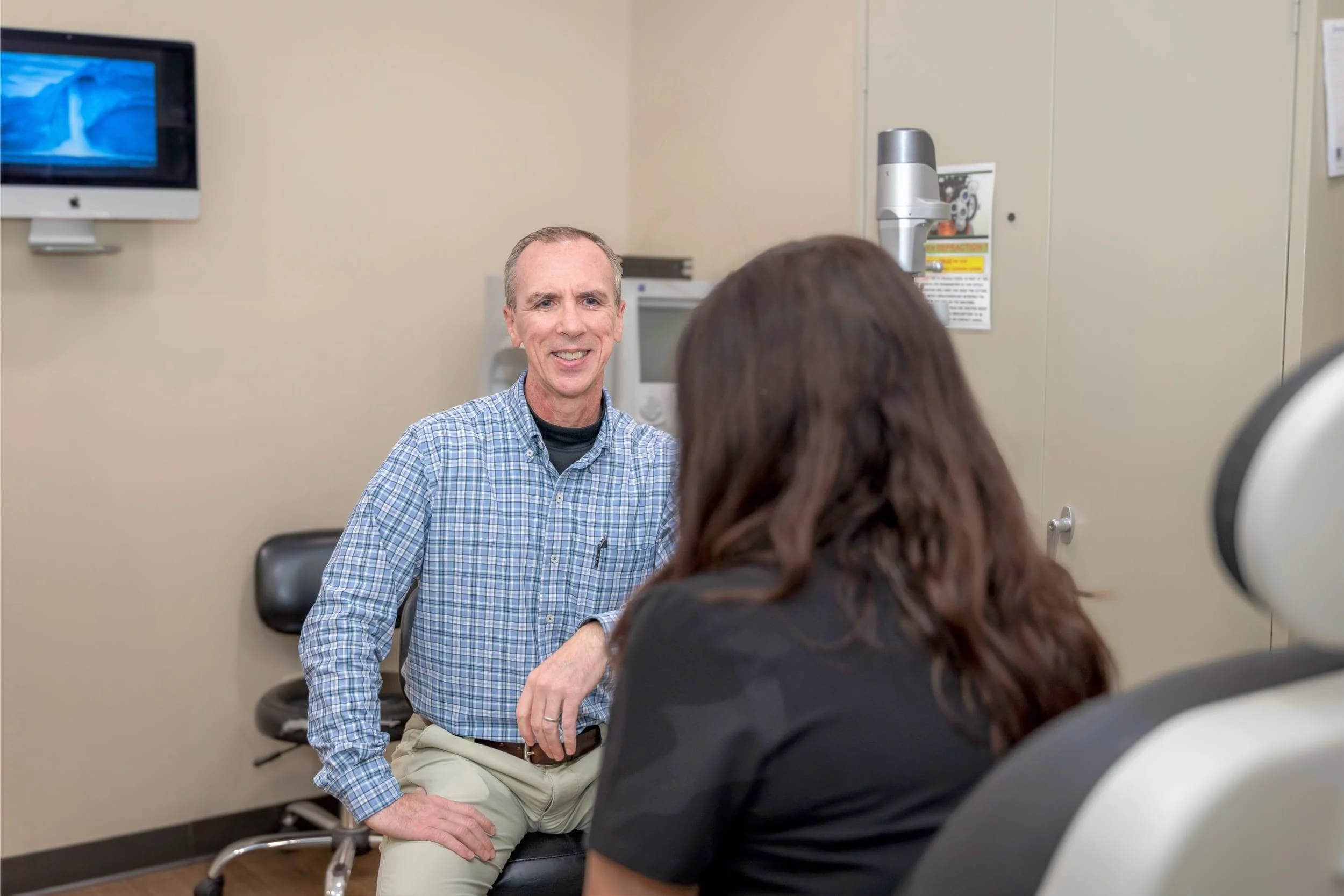 Friendly Optometrist Assisting Patient With Vision Exam in East Dublin, GA