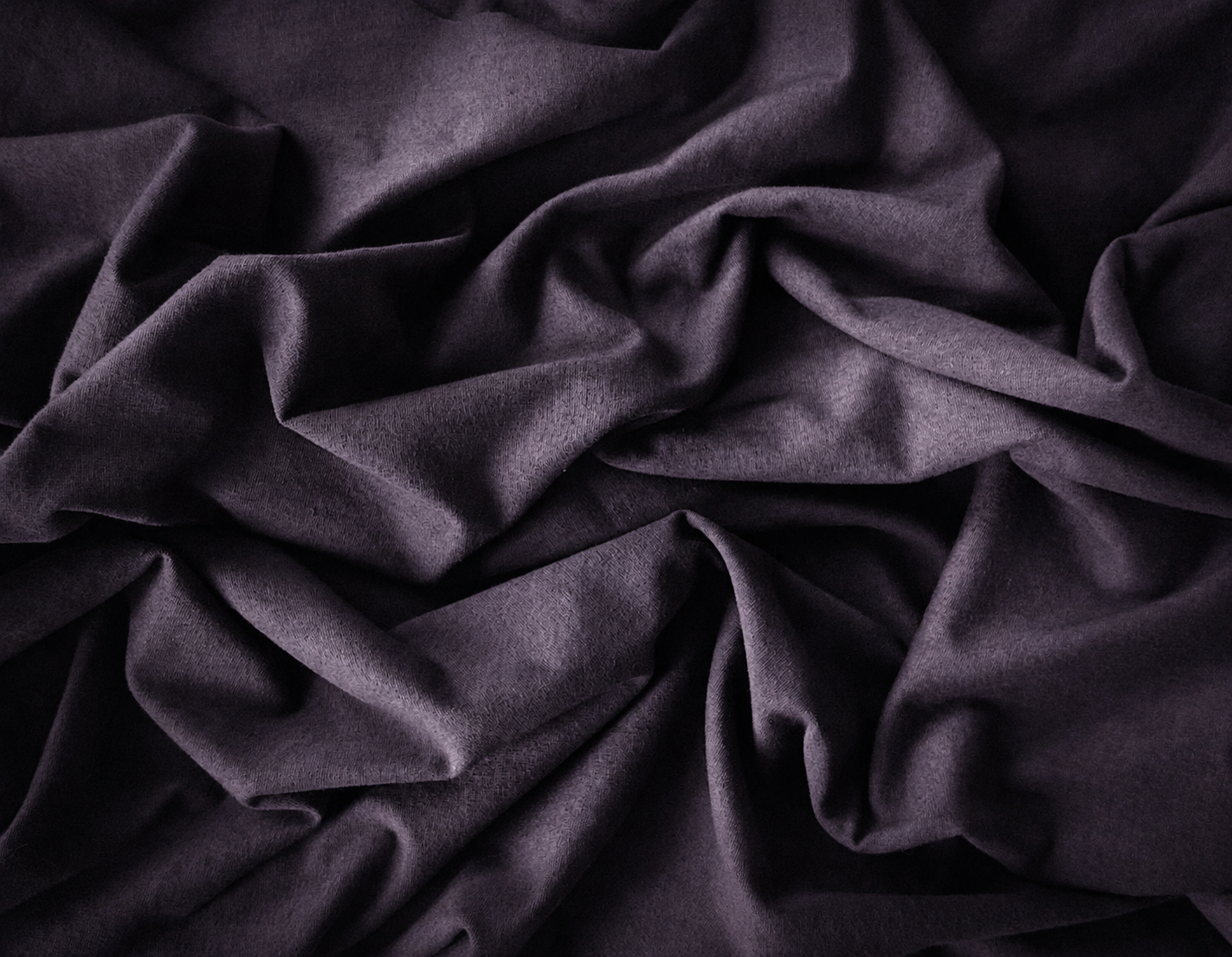 Crumpled dark gray fabric with soft texture.