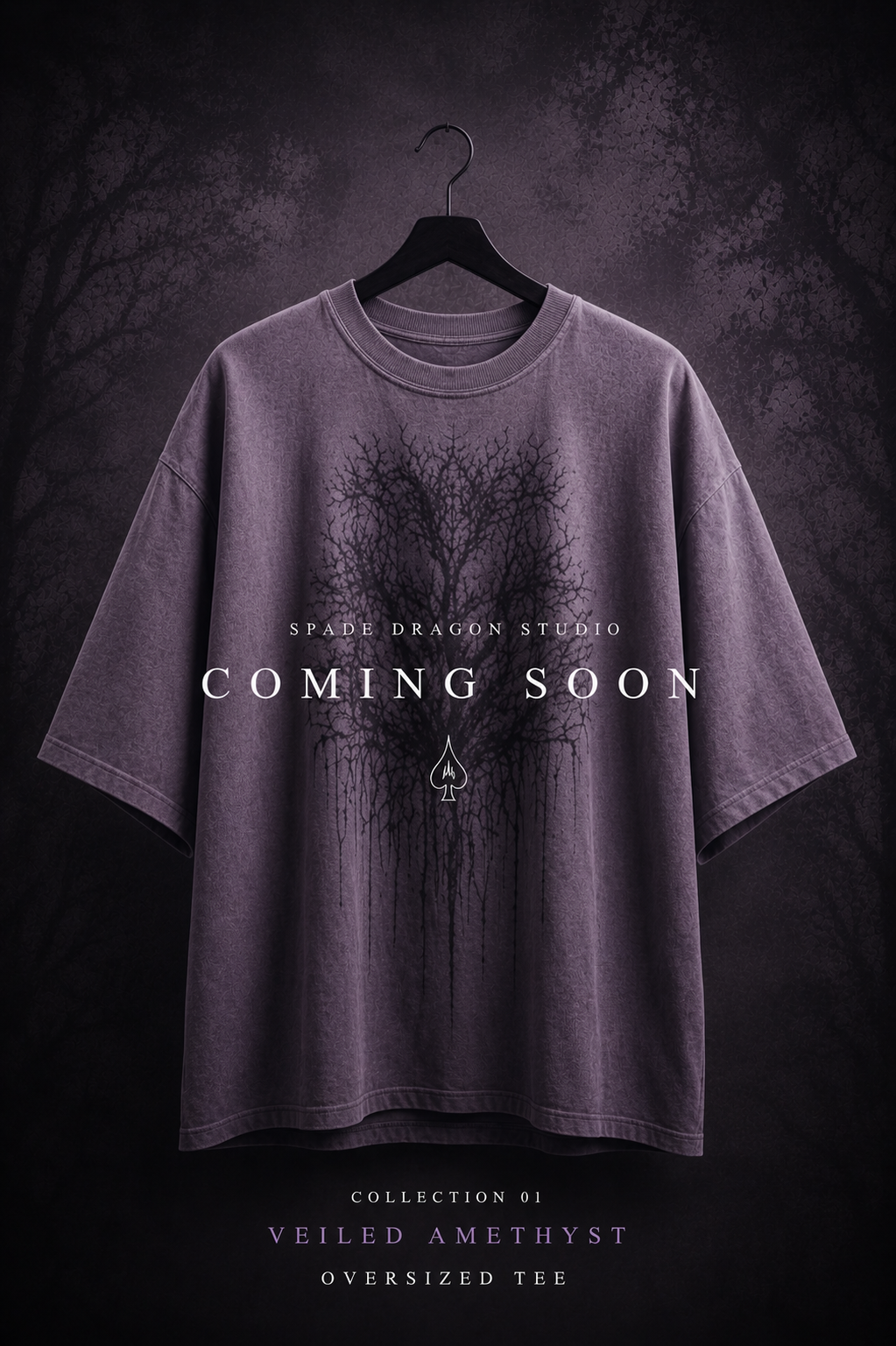 A purple oversized T-shirt with a black veiled amethyst logo and design, hanging on a black hanger, with dark background and promotional text for upcoming collection.