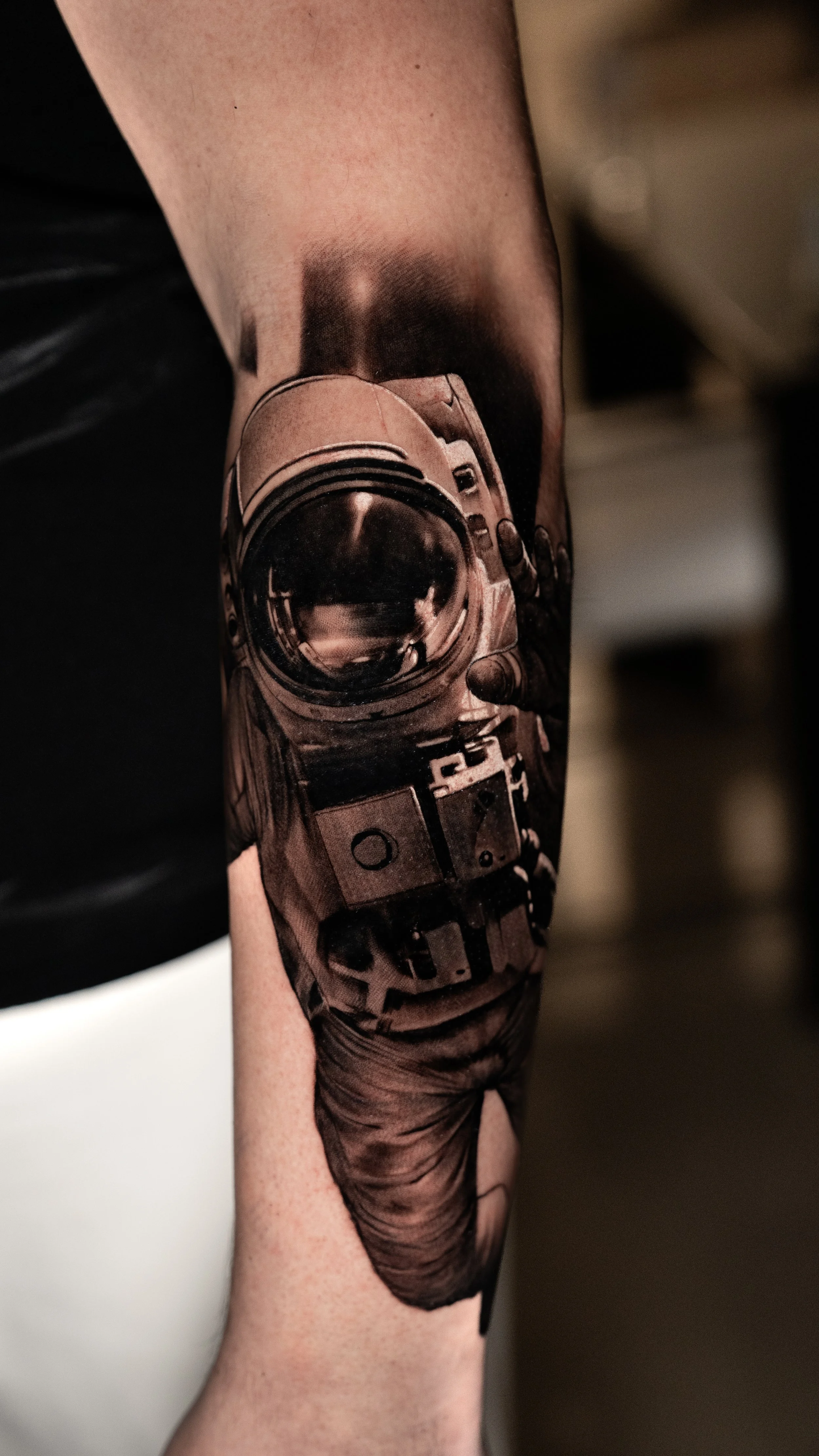 Tattoo of a vintage camera on a person's arm.