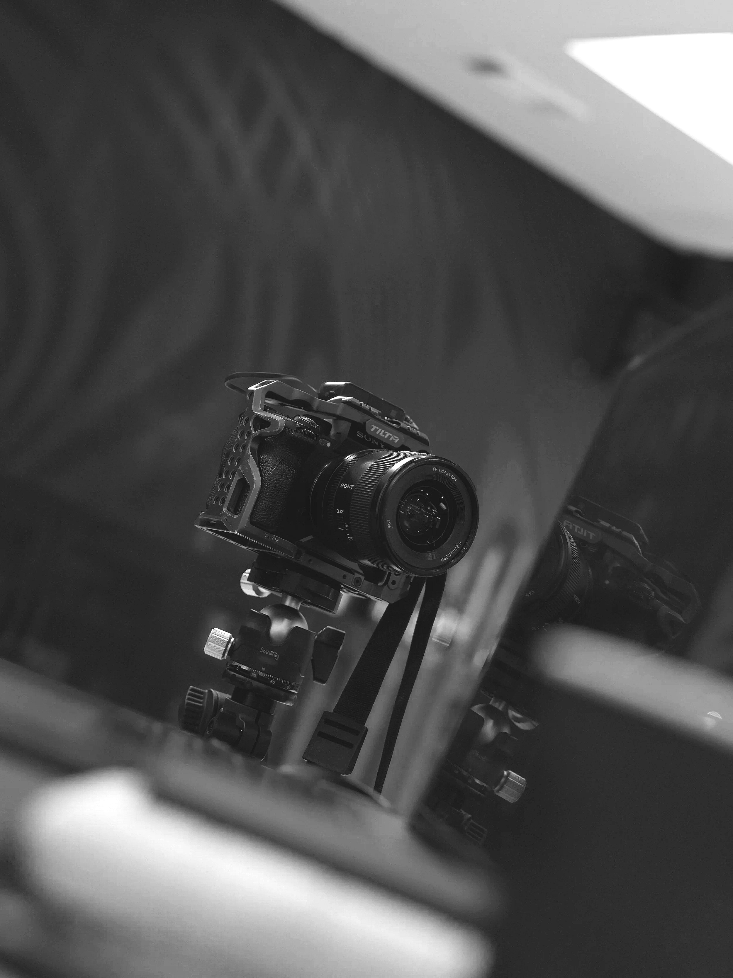 A camera mounted on a tripod, reflected in a mirror.