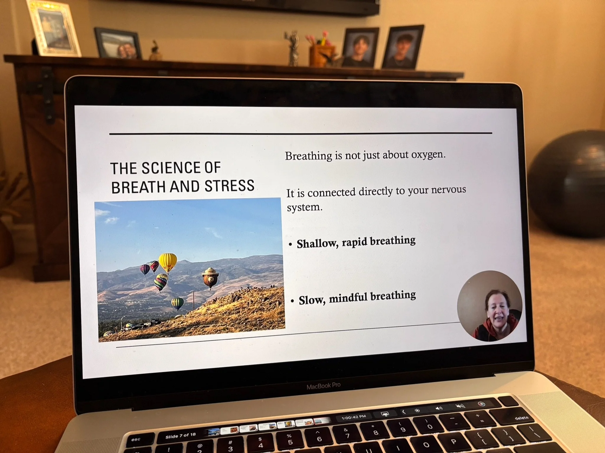 Laptop displaying a presentation slide titled "The Science of Breath and Stress" with an image of hot air balloons over a mountainous landscape, part of Dr Wendy Jordanov's Defying Gravity in Midlife 10 day online course.
