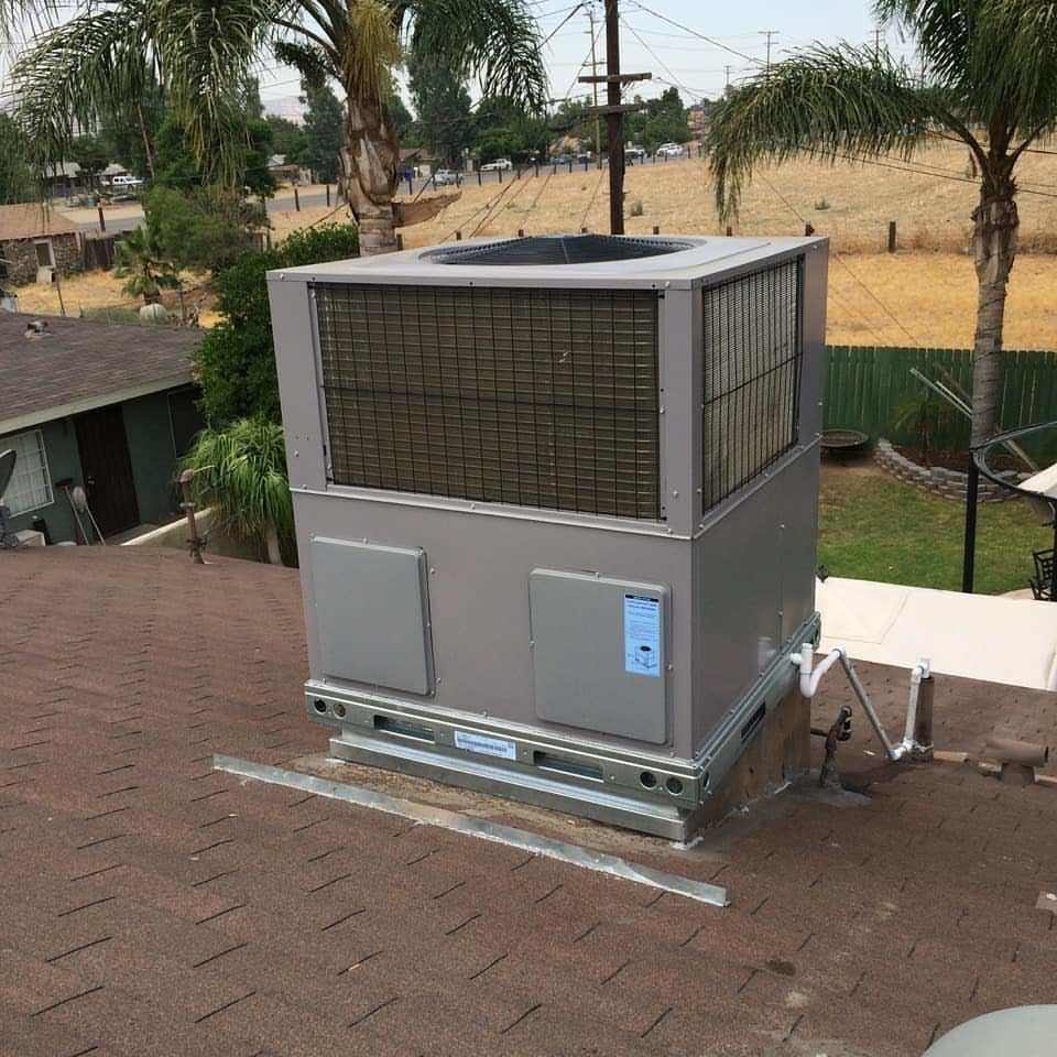 Central air conditioning unit installed on the rooftop of a house.