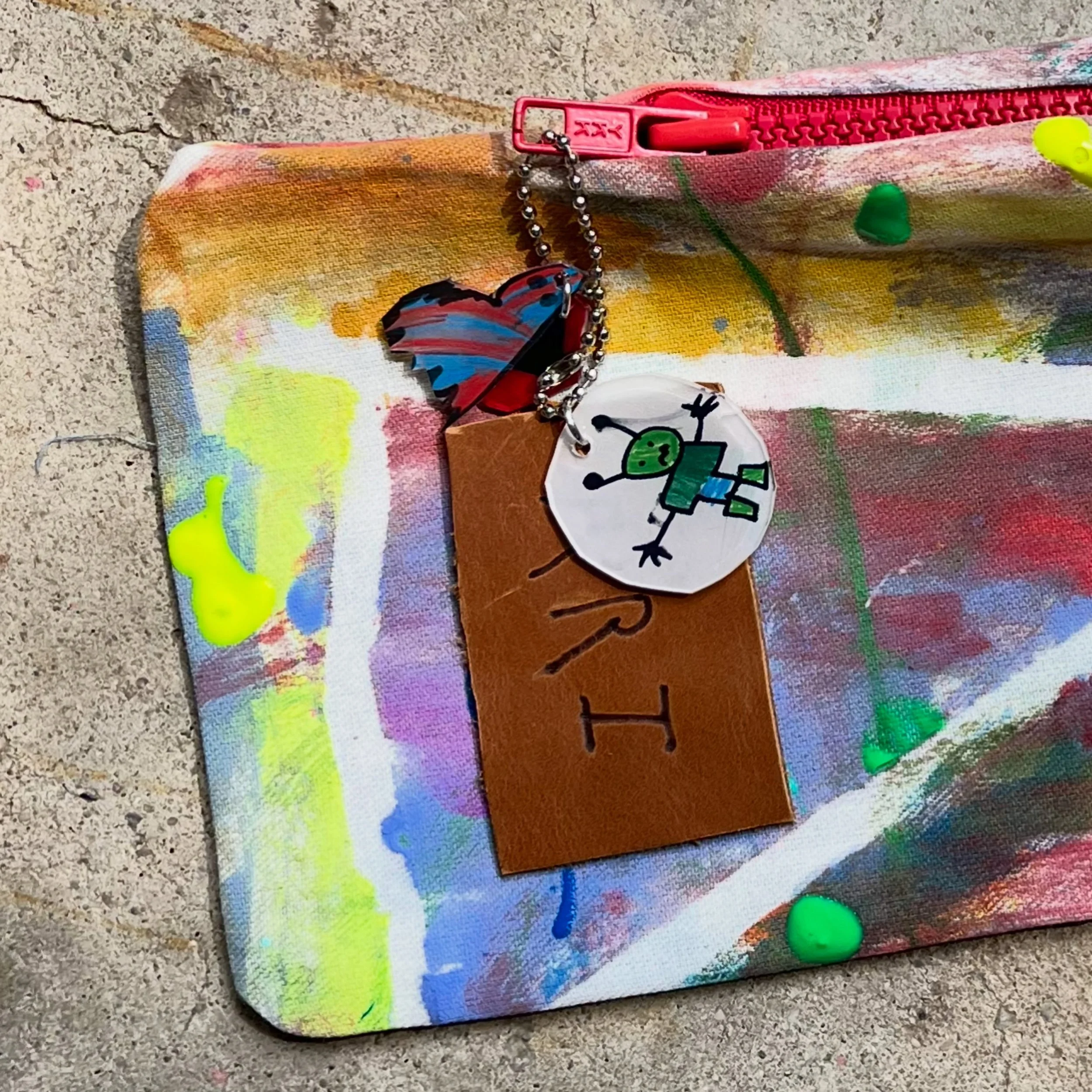 Handmade zipper pulls (for handmade pencil pouches). Shrinkadinks and leather scraps burned with a heat pen. Destined to be an heirloom!