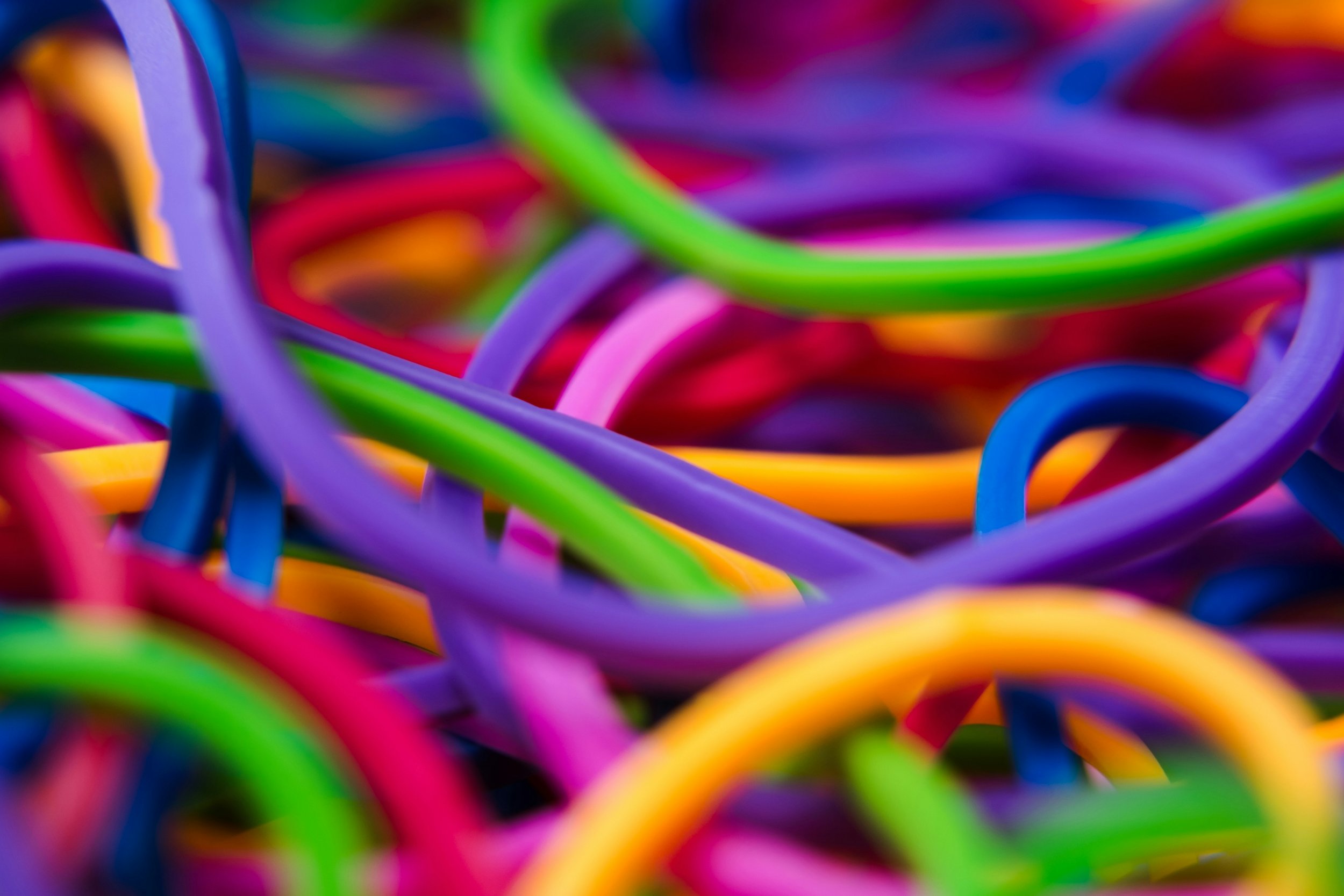 Close-up of colorful rubber bands tangled together.