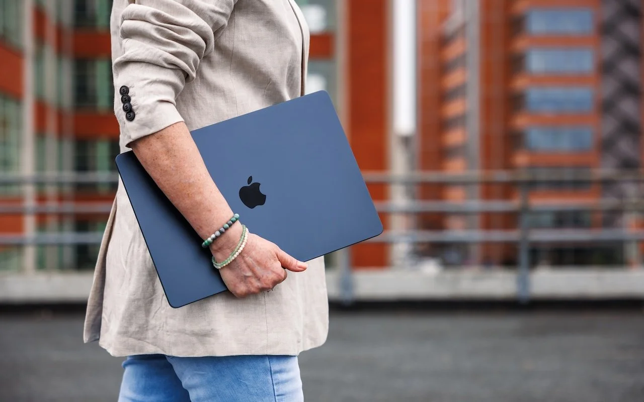 student-carrying-macbook-air-photo.jpg
