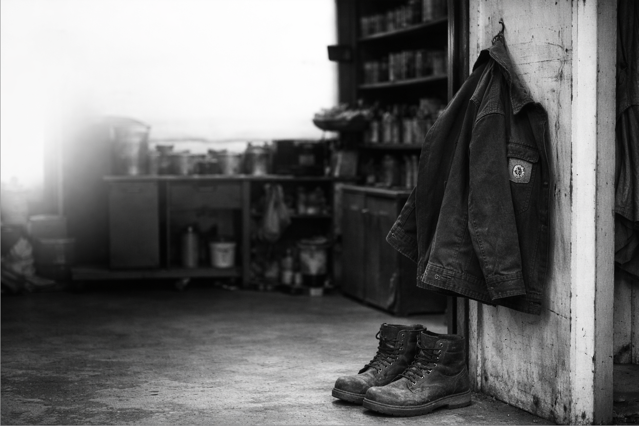 back of a shop area with work boots and work jacket