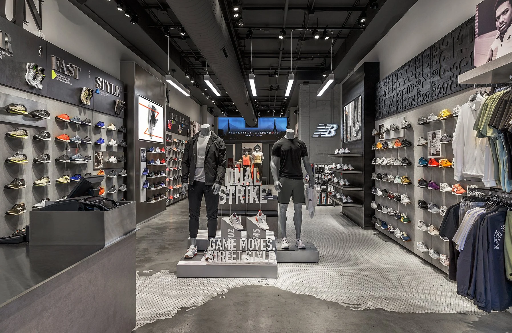 Inside a retail sneaker store with shelves displaying various athletic shoes, mannequins dressed in athletic wear, and promotional signs reading "DUAL STRIKE," "GAME MOVES," and "STREET STYLE."