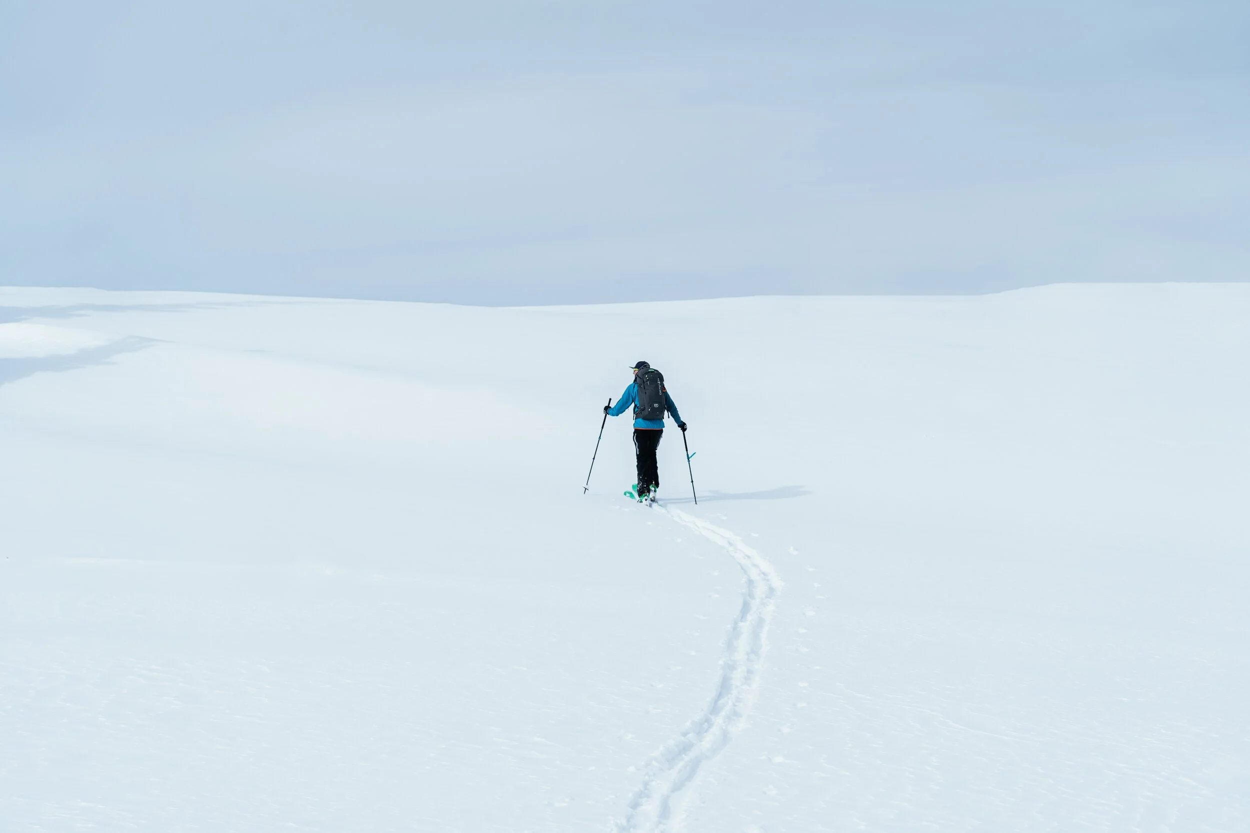 Minimalist photo of a skier backcountry skiing