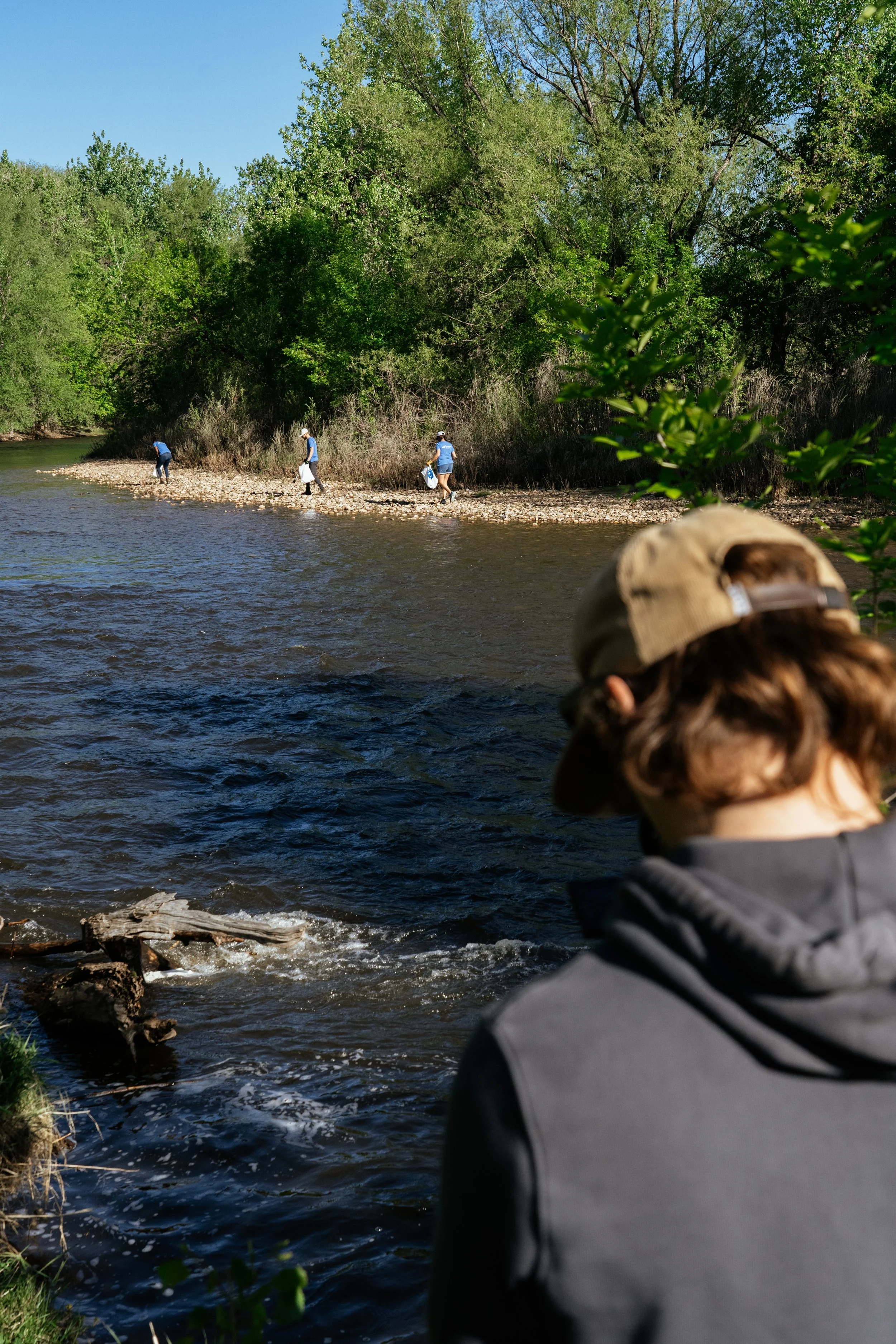 Roo Smith, commercial director, filming next to a river of a river cleanup