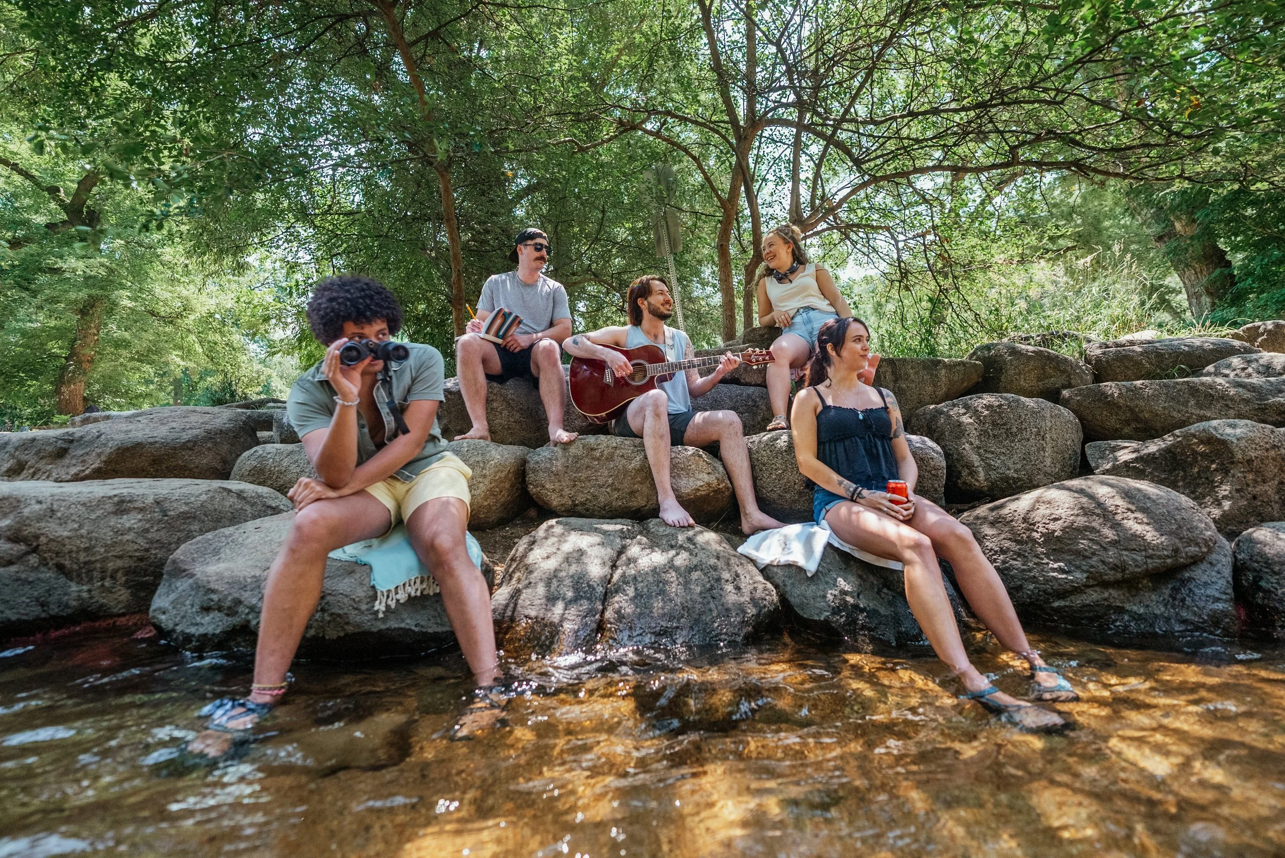 group sitting by the creek