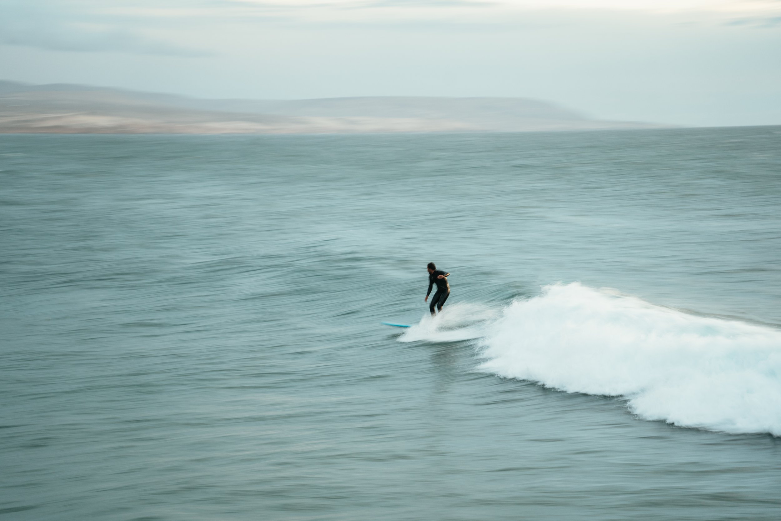 surfer on wave with low shutter speed