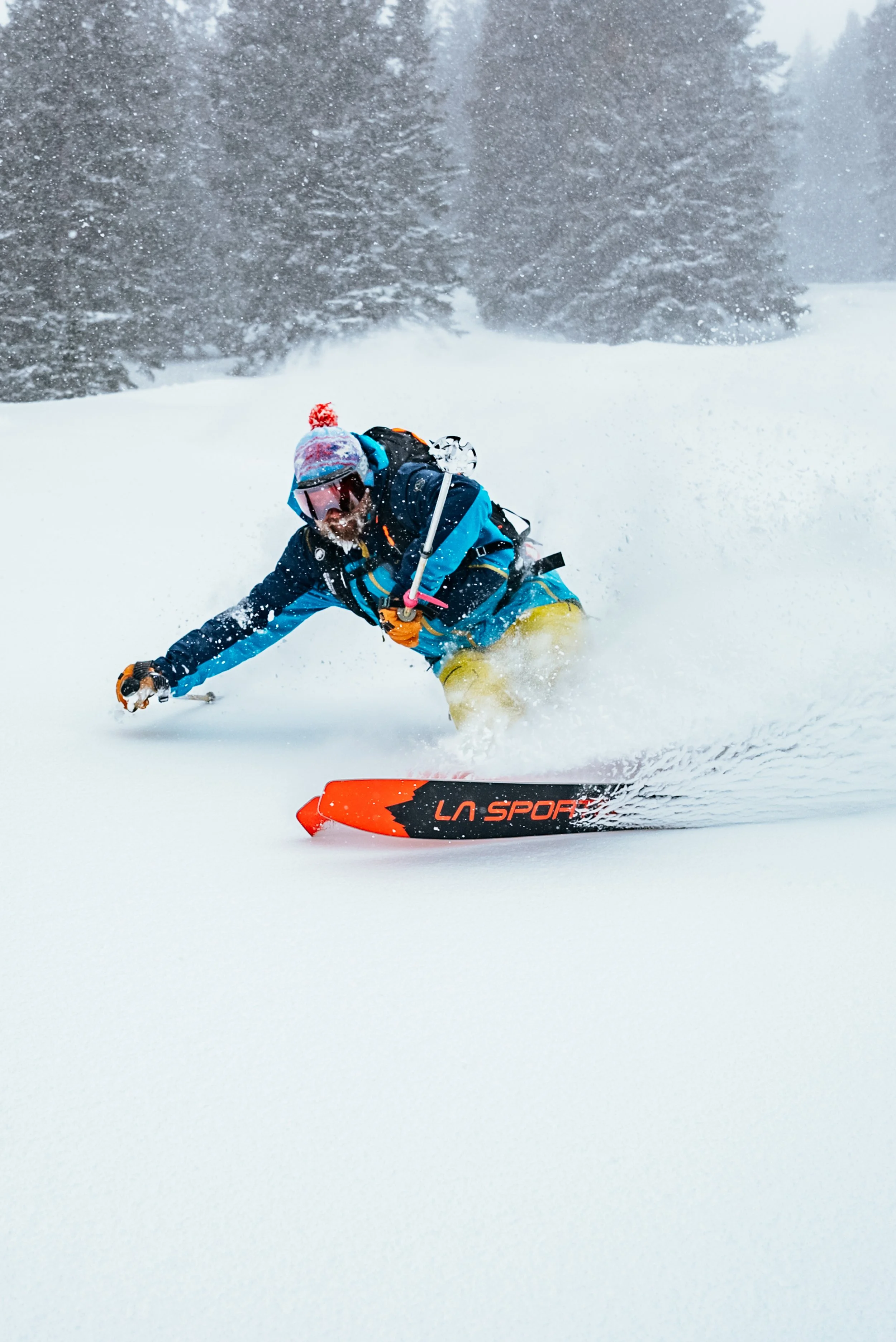 a skier for La Sporitva riding through powder