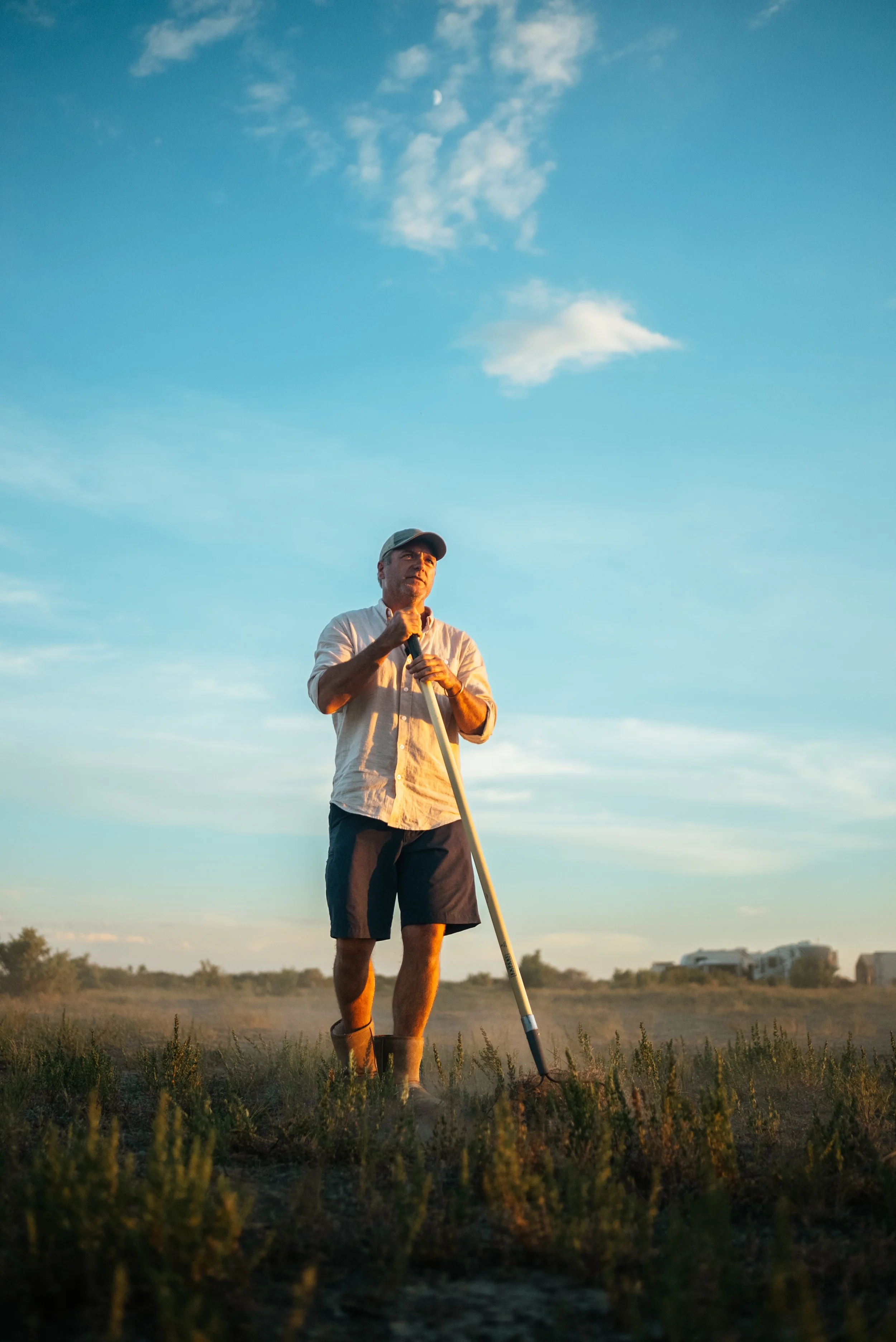 farmer standing in the sunset