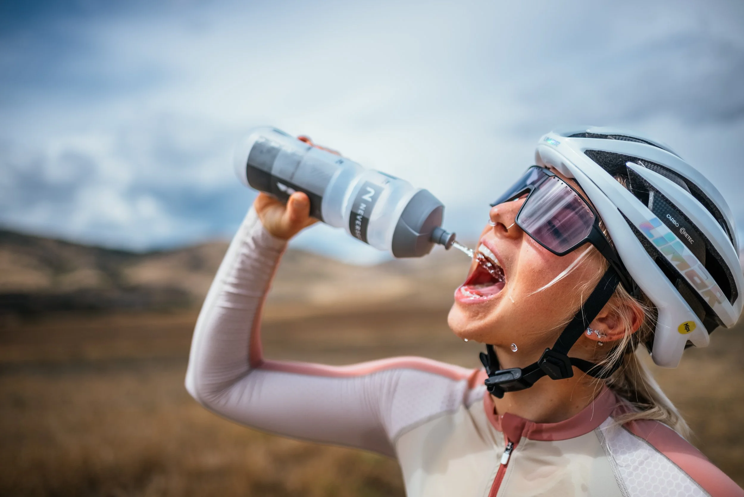 water bottle squirting in cyclist's mouth