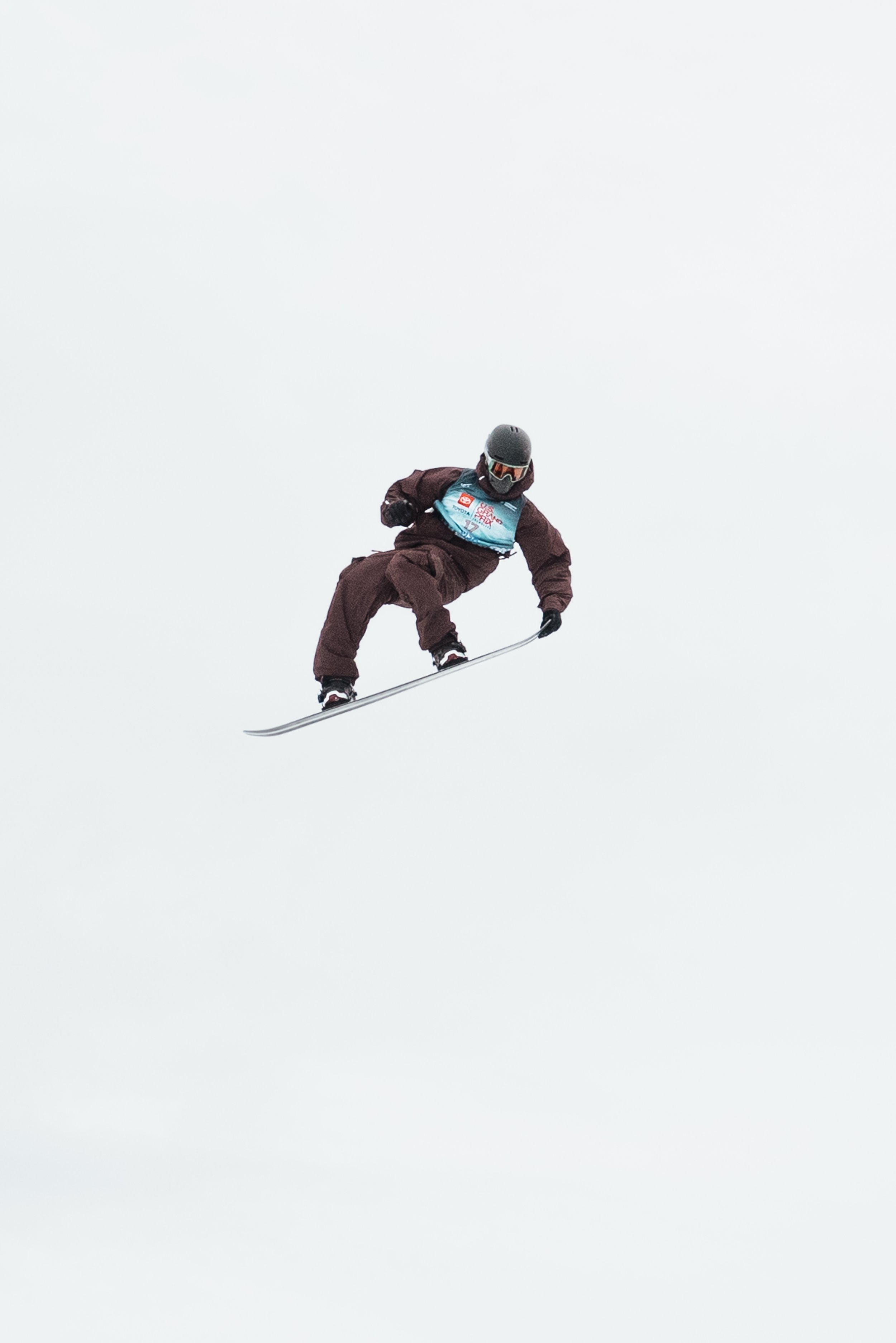 snowboarding against the sky grabbing his board